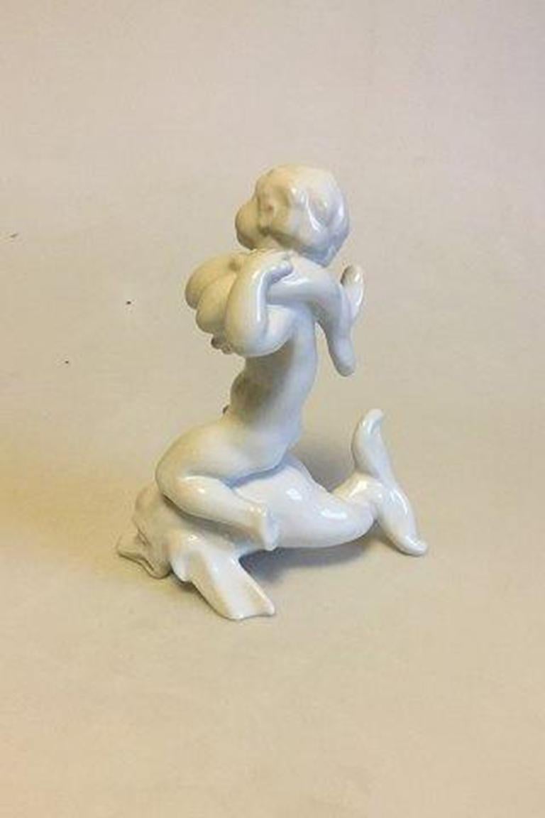 Bing & Grondahl figurine No 4058 boy on dolphin. Blanc de Chine. By Kai Nielsen. 

Measures: 20 cm / 7 7/8 in. 

Old B&G Stamp. 

In perfect condition.

