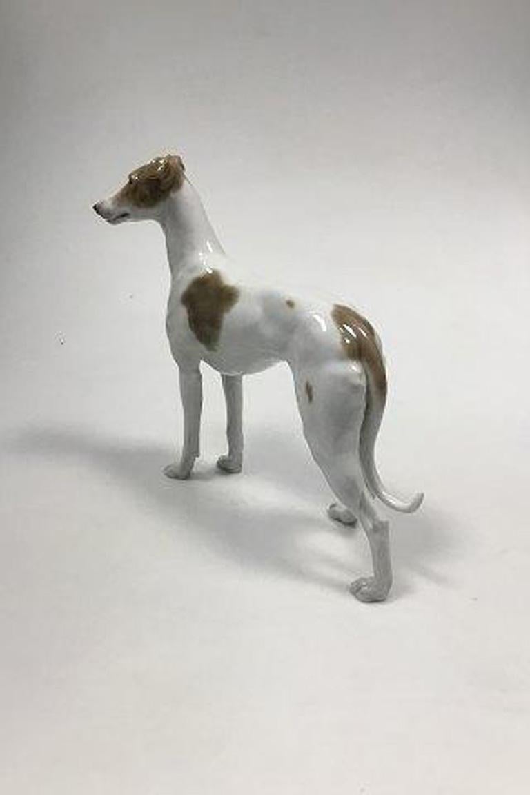 Bing & Grondahl figurine of greyhound no 2076.

Measures 24 cm / 9 29/64 in.
 