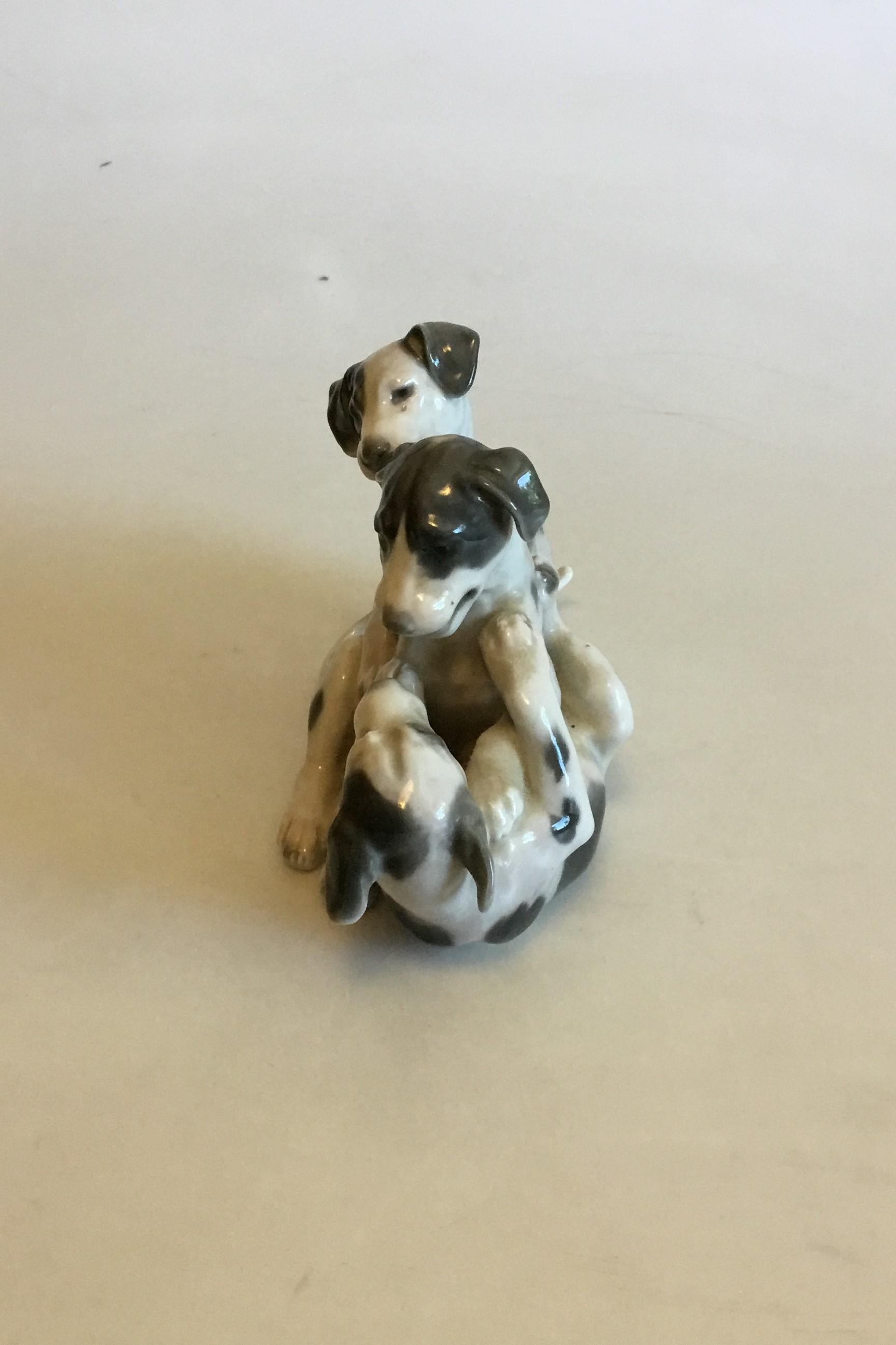 Bing & Grondahl figurine of three pointer puppies playing no 1815. Signed L.J. (Lauritz Jensen) The Tale is glued on.