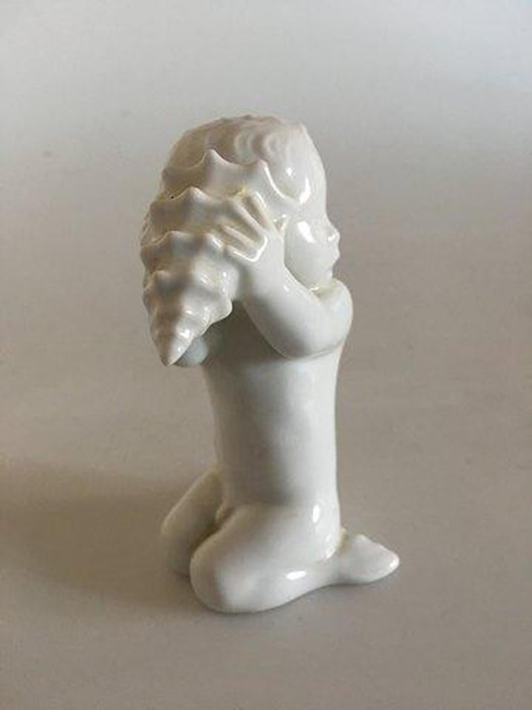 Bing & Grondahl Figurine Sea Boy with shell No 2264 and is in good condition. Designed by Ebbe Sadolin/Svend Jespersen.

Measures 11 cm / 4 21/64 in.