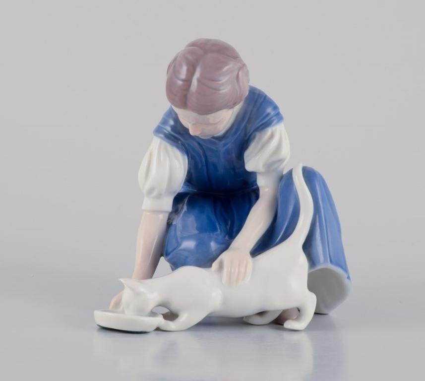 Bing & Grondahl porcelain figurine. Girl with cat. 
Mid 20th c.
Model number: 1745.
In perfect condition.
Marked.
First factory quality.
Dimensions: W 15.5 cm. x H 14.0 cm.

