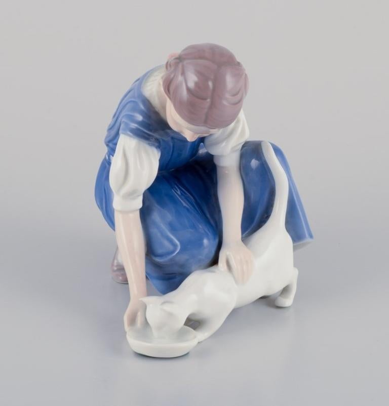 Danish Bing & Grondahl porcelain figurine. Girl with cat.  Mid 20th c. For Sale