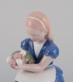 Bing & Grondahl. Porcelain figurine of a seated girl with flowers, 1930s
