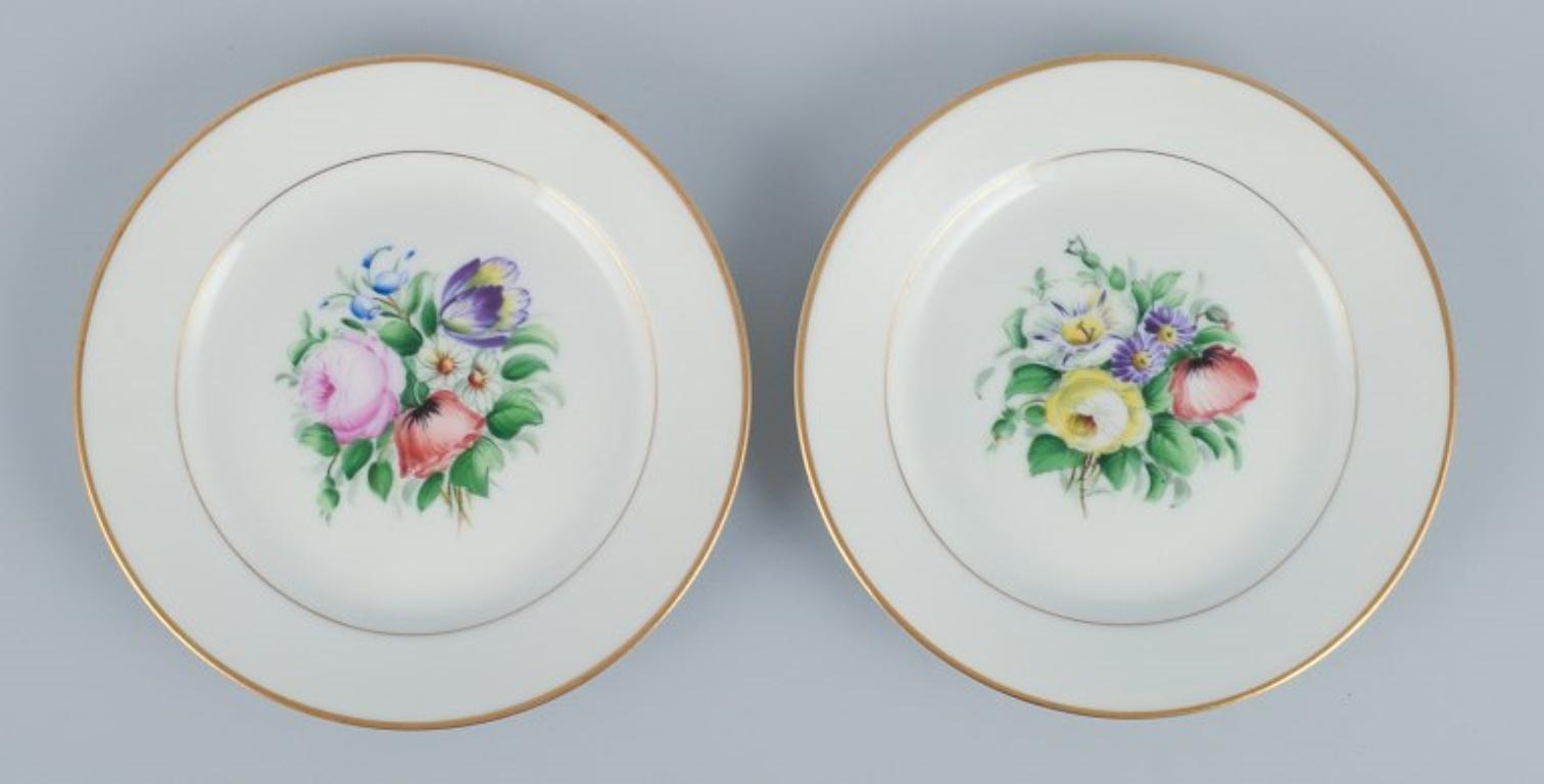 Early 20th Century Bing & Grondahl, set of fourteen plates hand-painted with flowers. For Sale