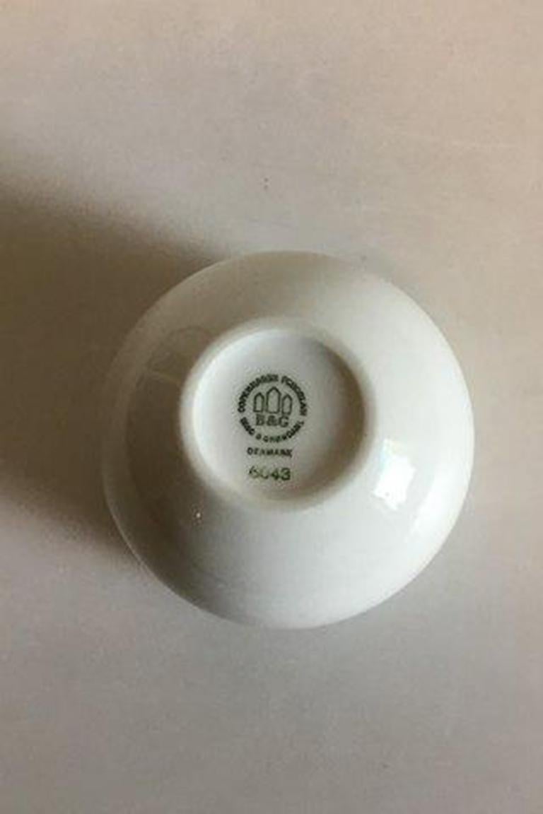 Bing & Grondahl white candle holder No 6043. 

Measures 7.5 cm / 2 61/64 in. x 8 cm / 3 5/32 in. diameter.
 