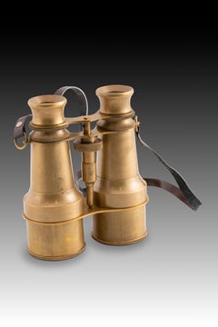 Binocolo con finitura antica. Metallo placcato oro, altro.  XX secolo.