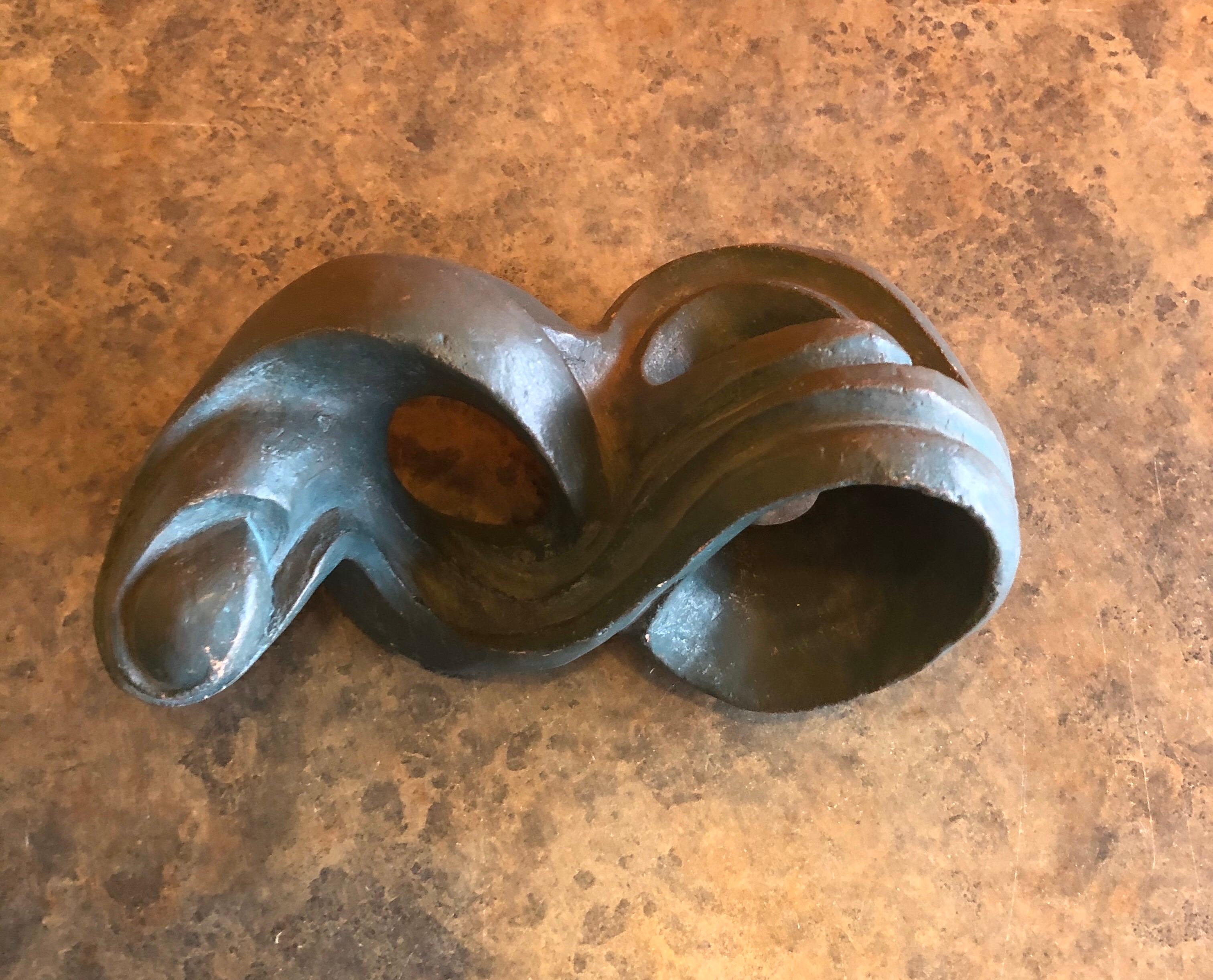 A very cool biomorphic abstact pottery sculpture by California listed artist Robert Ortlieb, circa 1970s. The piece is hand thrown terracotta pottery painted in with a flat light green paint.