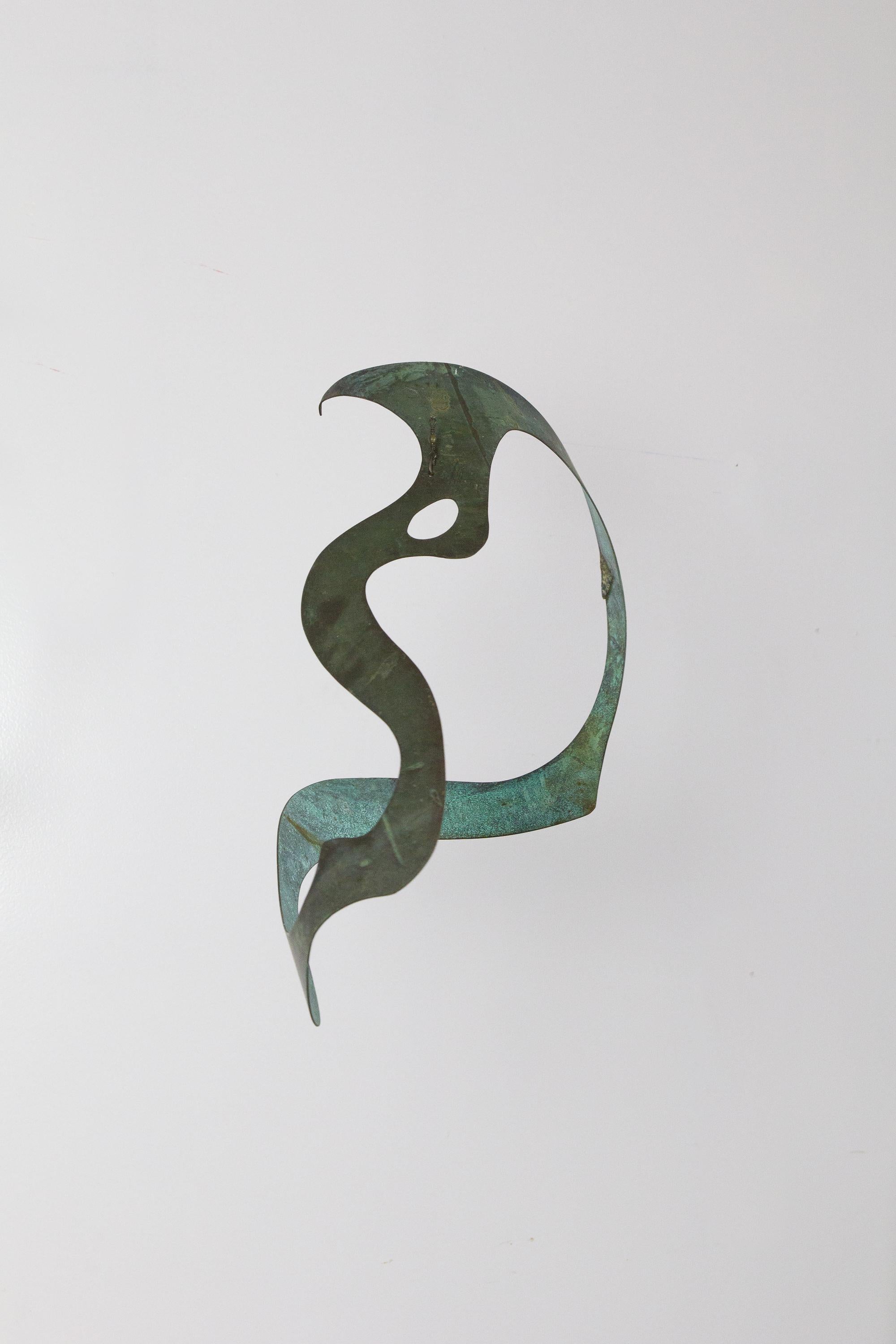 Handmade biomorphic patinated bronze hanging sculpture for use indoors or out. Form is dramatically different depending on the viewing angle. Retains original hanging hook.