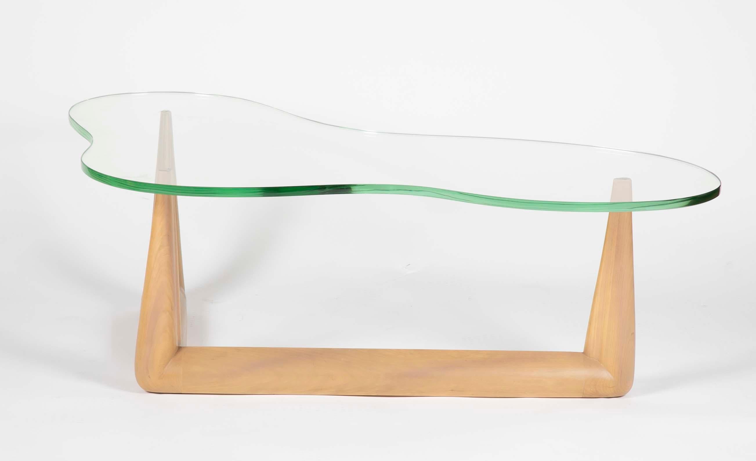 A bleached mahogany glass top amoeba form coffee table designed by T.H. Robsjohn-Gibbings coffee table.
