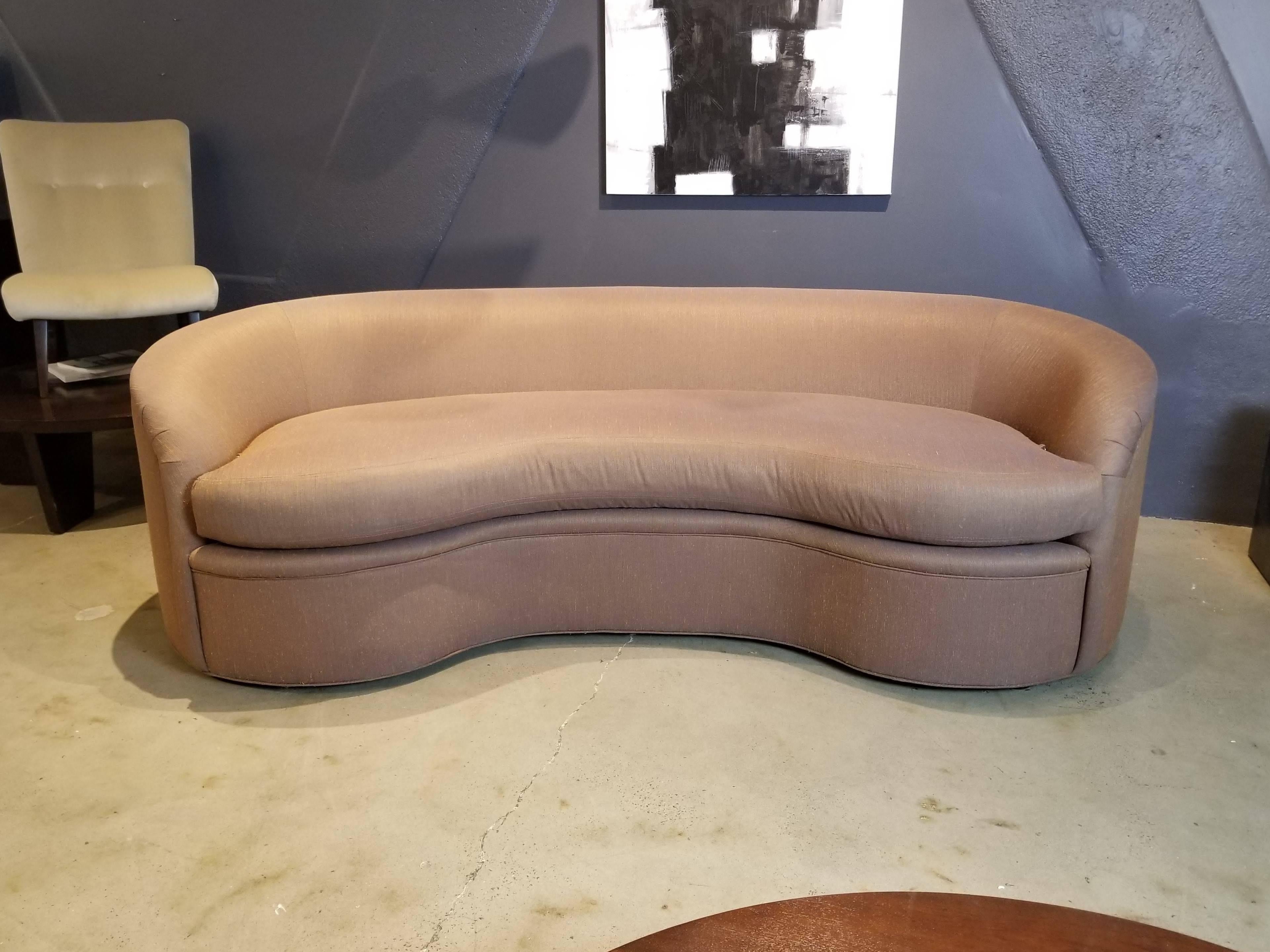 Classic biomorphic kidney bean shaped curved sofa made by Directional Furniture. Structurally in pristine, like-new condition. Currently upholstered in a deep rosy beige silk shantung that is in very good condition with a few minor light surface