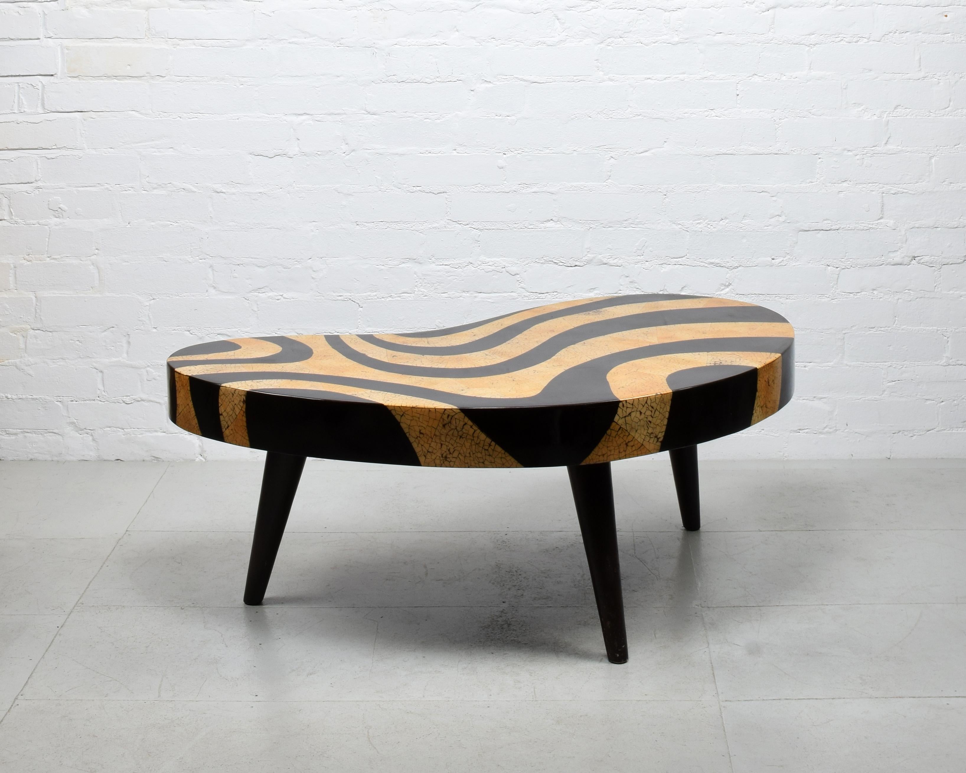 Biomorphic kidney-shaped coffee table, Mid-century style, c. 1980s

Zebra/tiger faux eggshell lacquer mosaic and inlaid wood pattern print finish on composite top, wooden legs

A truly striking and unusual but usable item, in good condition with
