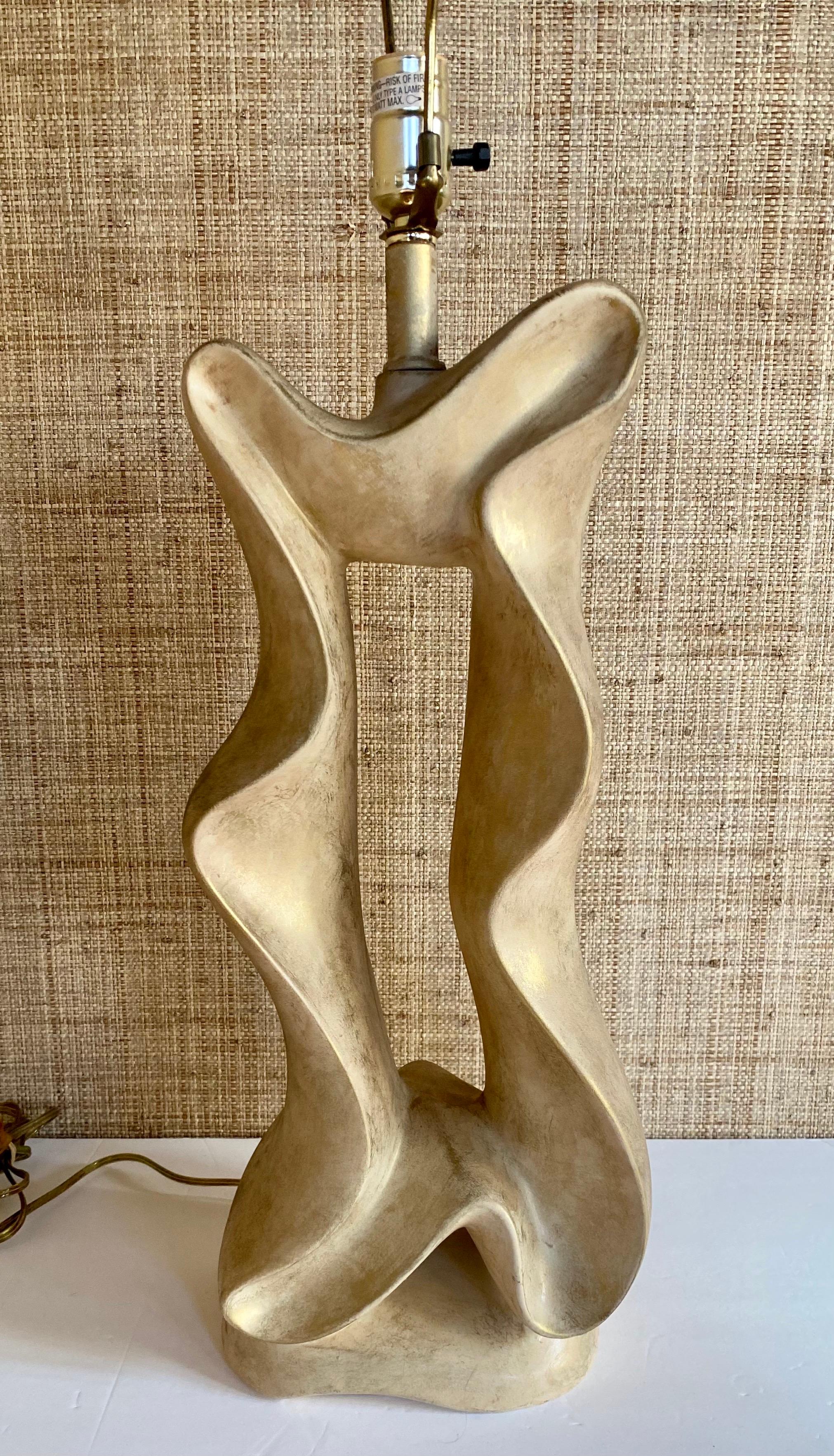 Very unique Post Modern biomorphic table lamp by Jaru. This sculptural abstract form lamp features a neutral tone finish with metallic gold accents. Circa 1980's. Lamp shade not included. 

Measures: Height to finial: 31 inches. 
Height to
