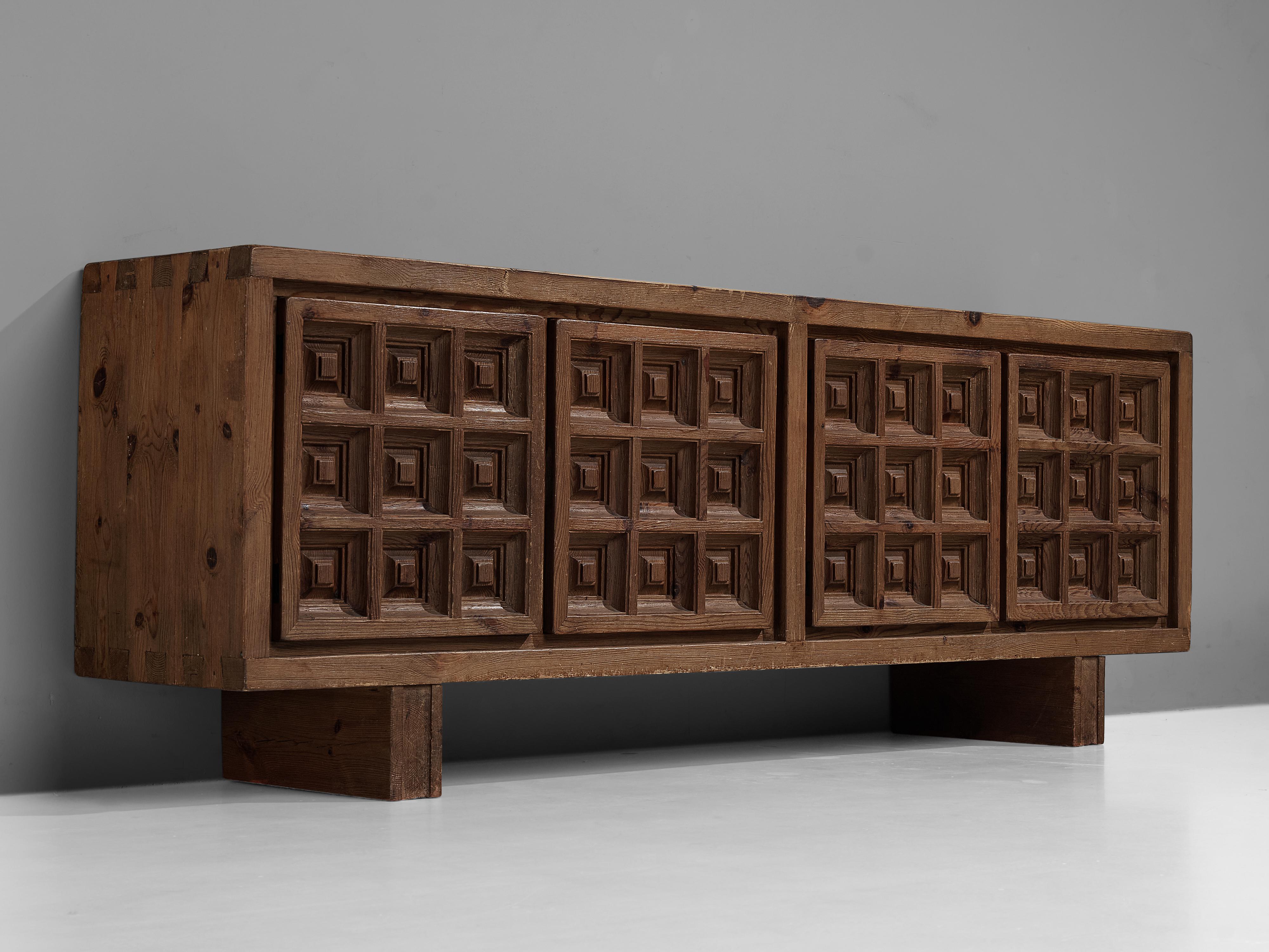 Biosca, sideboard, stained pine, Spain, 1960s.

Outstanding Spanish sideboard that is executed by Biosca in a beautiful way. The four-door credenza features doors with a graphic carved pattern. This is very typical for Brutalist style, while the
