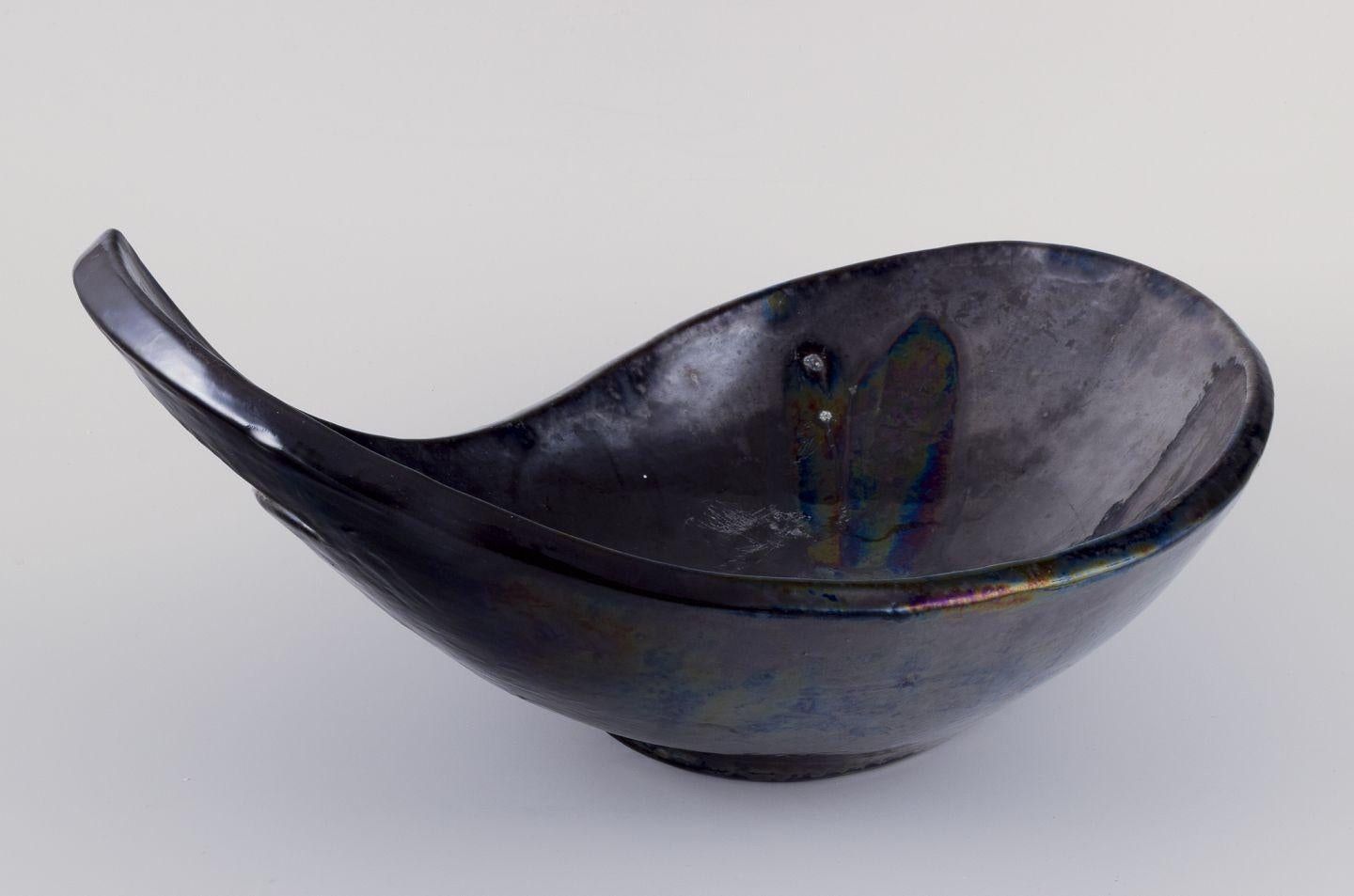 Pre-owned goods are exempt from import duties for U.S. customers. 
Therefore, no import tariffs will be applicable to your purchase.

Biot, France.
Large ceramic bowl. Organic form.
Matte glaze in dark tones.
1970s
Signed with artist's