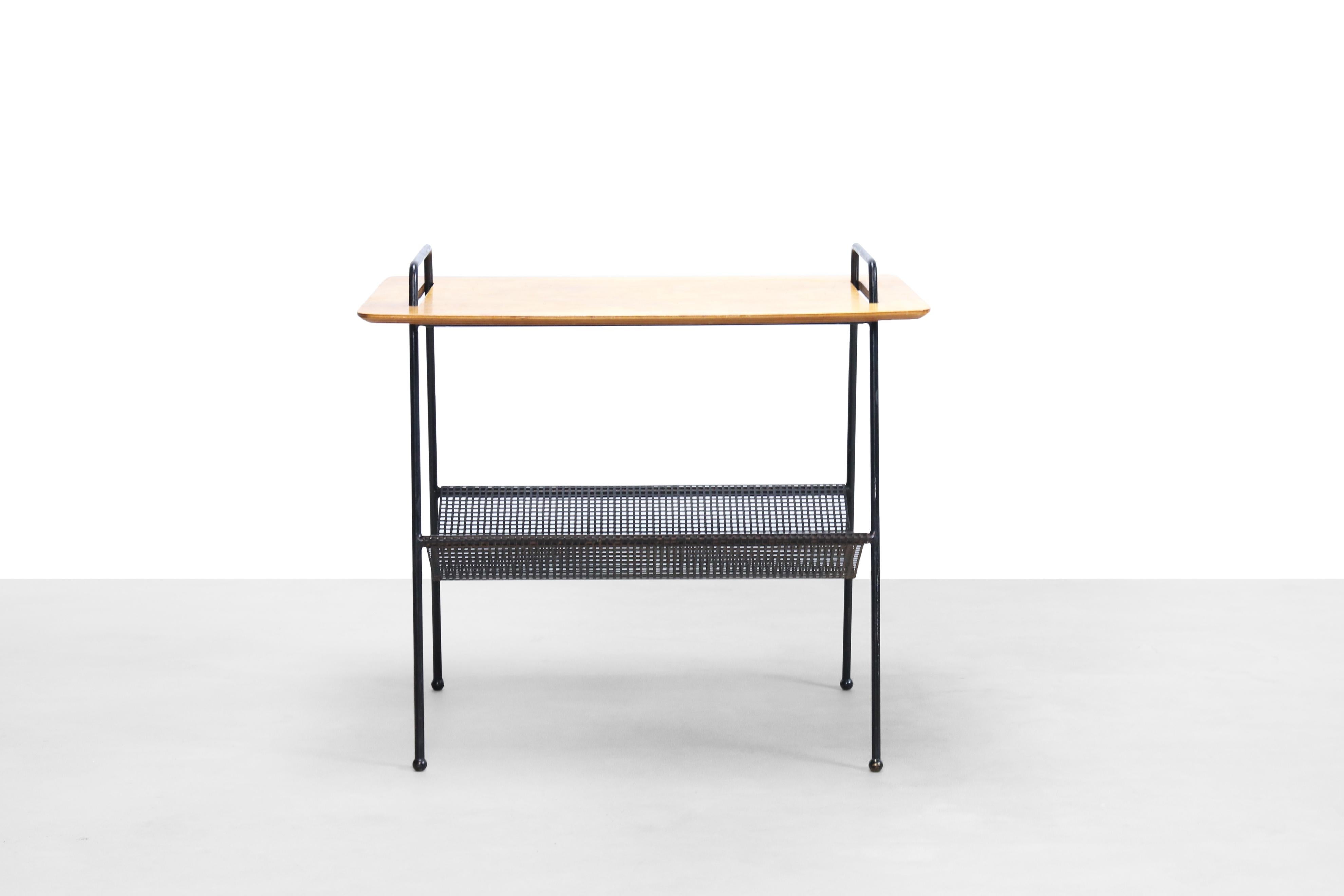 Rare side table with magazine rack by Cees Braakman for Pastoe, 1953. This is the TM04 from the Combex series. This side table is made of a black lacquered base, black lacquered perforated newspaper / magazine rack and a birch plywood top.
