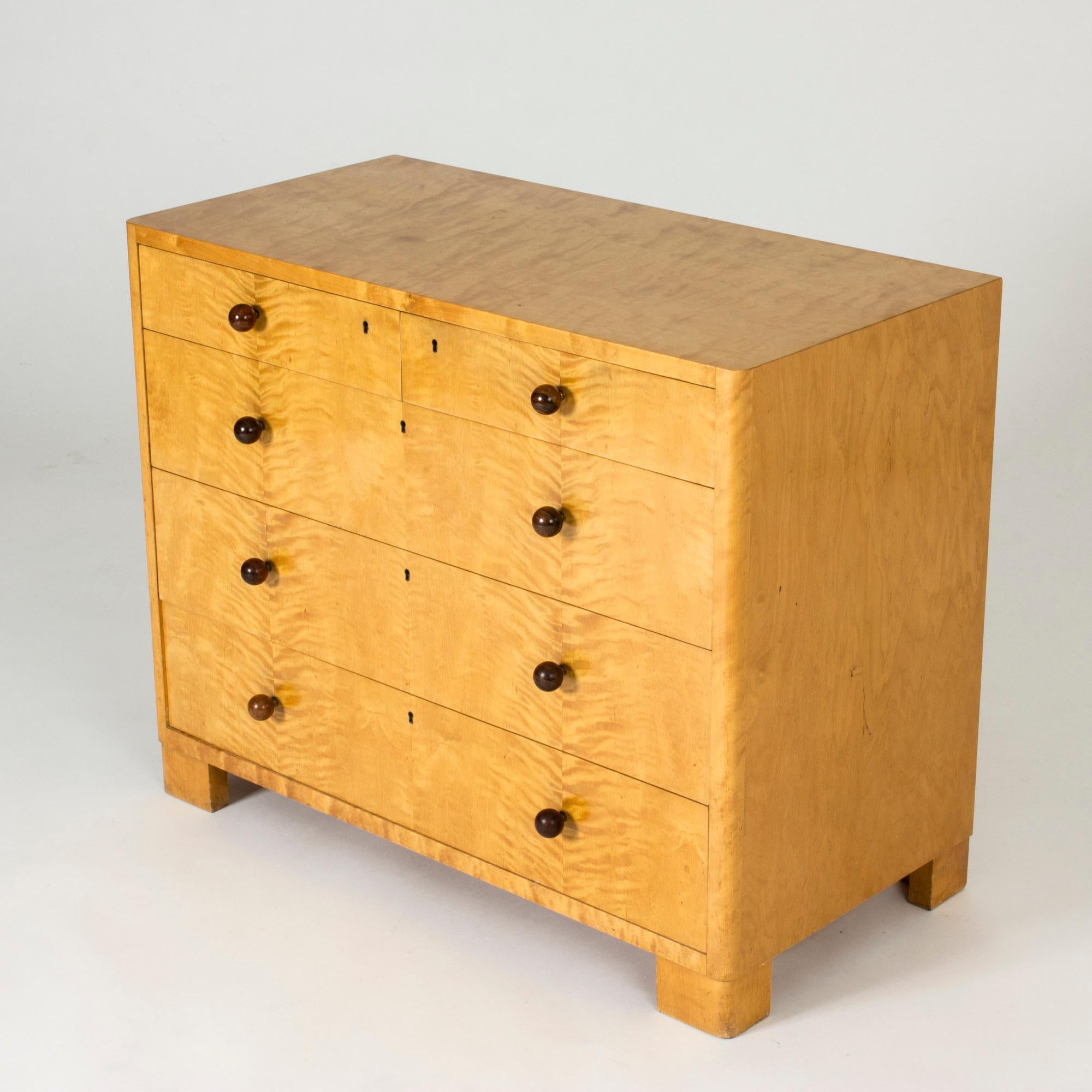 Amazing functionalist chest of drawers by Axel Larsson, made in from birch with round darker wood knobs on the drawers. Clean lines, chunky square legs.