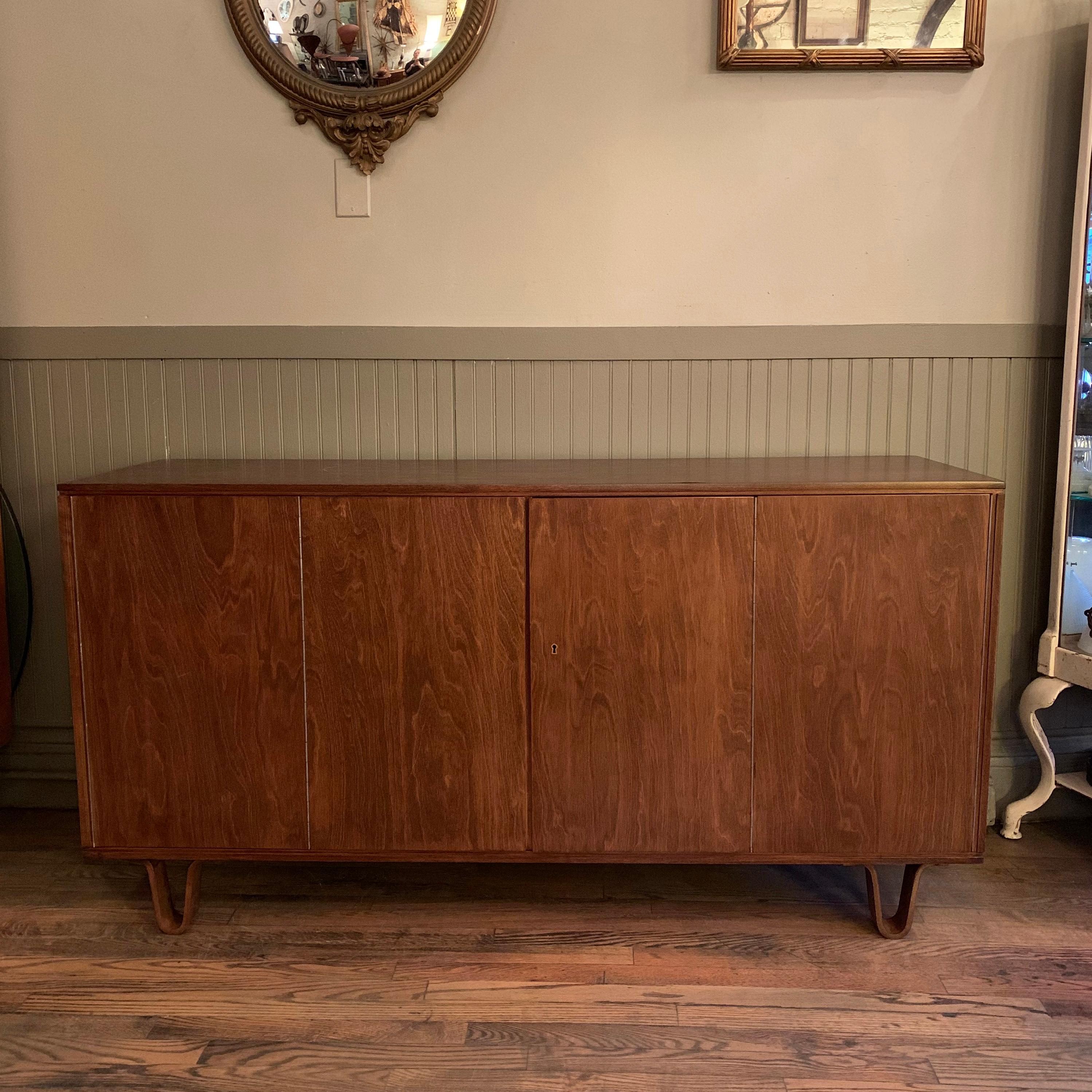 Mid-Century Modern, birch, sideboard / credenza by Cees Braakman for Pastoe, Combex series DB02 features a streamlined exterior with hinged doors and bentwood legs. The interior provides ample interior storage with shelves and pullout / pull-out