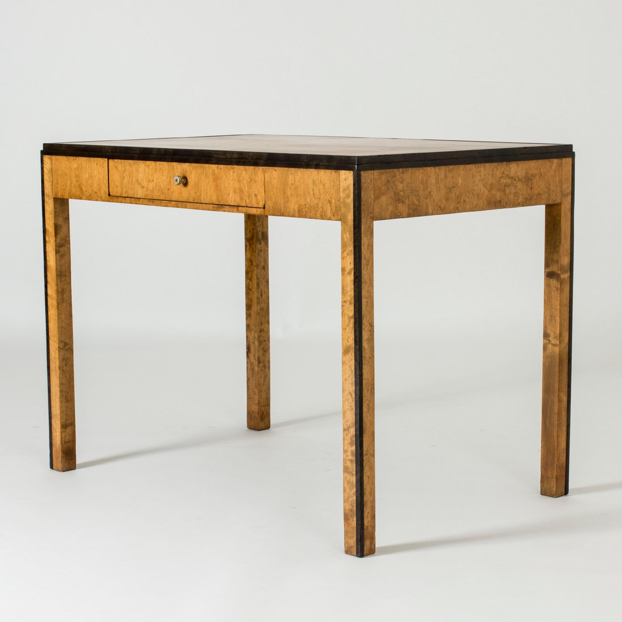 Elegant functionalist desk “Sara” by Axel Einar Hjort, with clean lines. Made from birch with lively woodgrain. Black stripes along the legs and around the tabletop accentuate the silhouette. Neat size.

Provenance: This piece was purchased from