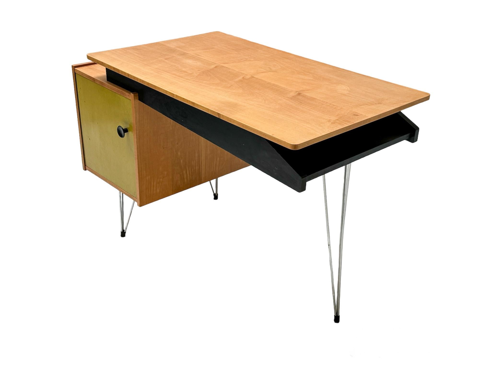 Stunning and rare Mid-Century Modern desk or writing table.
Design by Cees Braakman for Pastoe.
Striking Dutch design from the 1950s.
Elegant birch frame with original lacquered door on original chrome hairpin legs.
Floating refinished birch