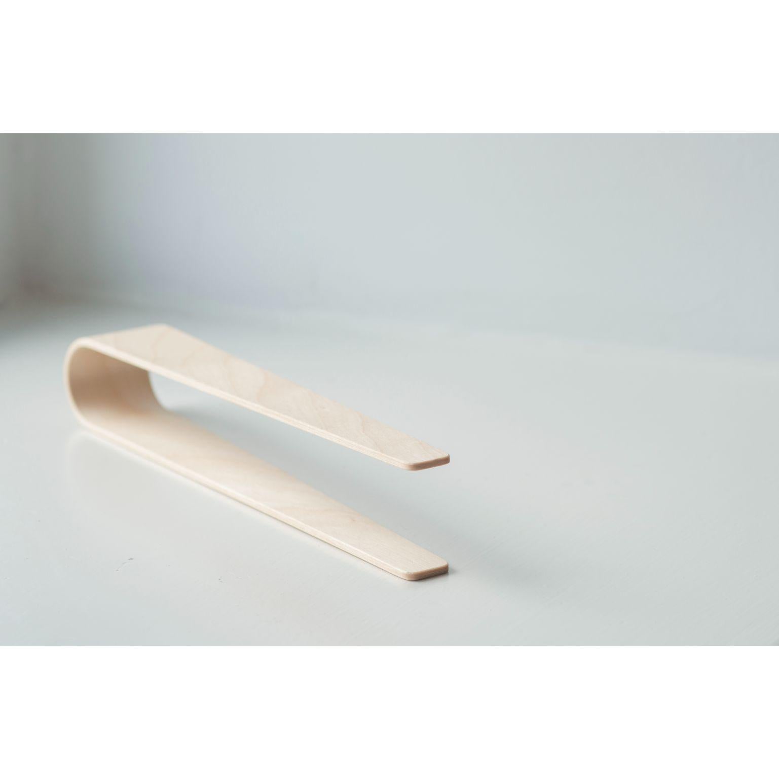 Birch Nokka tongs by Antrei Hartikainen
Materials: Walnut, maple, natural oil wax
Dimensions: W 24,5 D 4/2 H 6 cm

Also available in a variety of woods

Nokka tongs are suitable for serving a range of light foods including appetizers, salads,