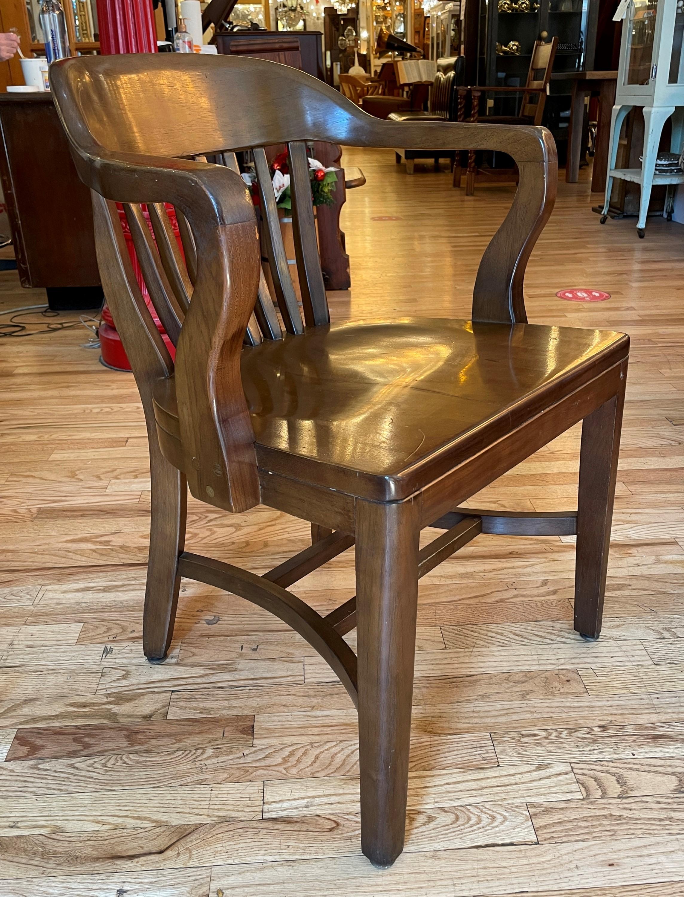 This solid walnut bankers chair with birch stain is made in a Bank of England style and exudes sophistication, with its rich wood finish, ergonomic design, and historical significance. Please note, this item is located in one of our NYC locations.