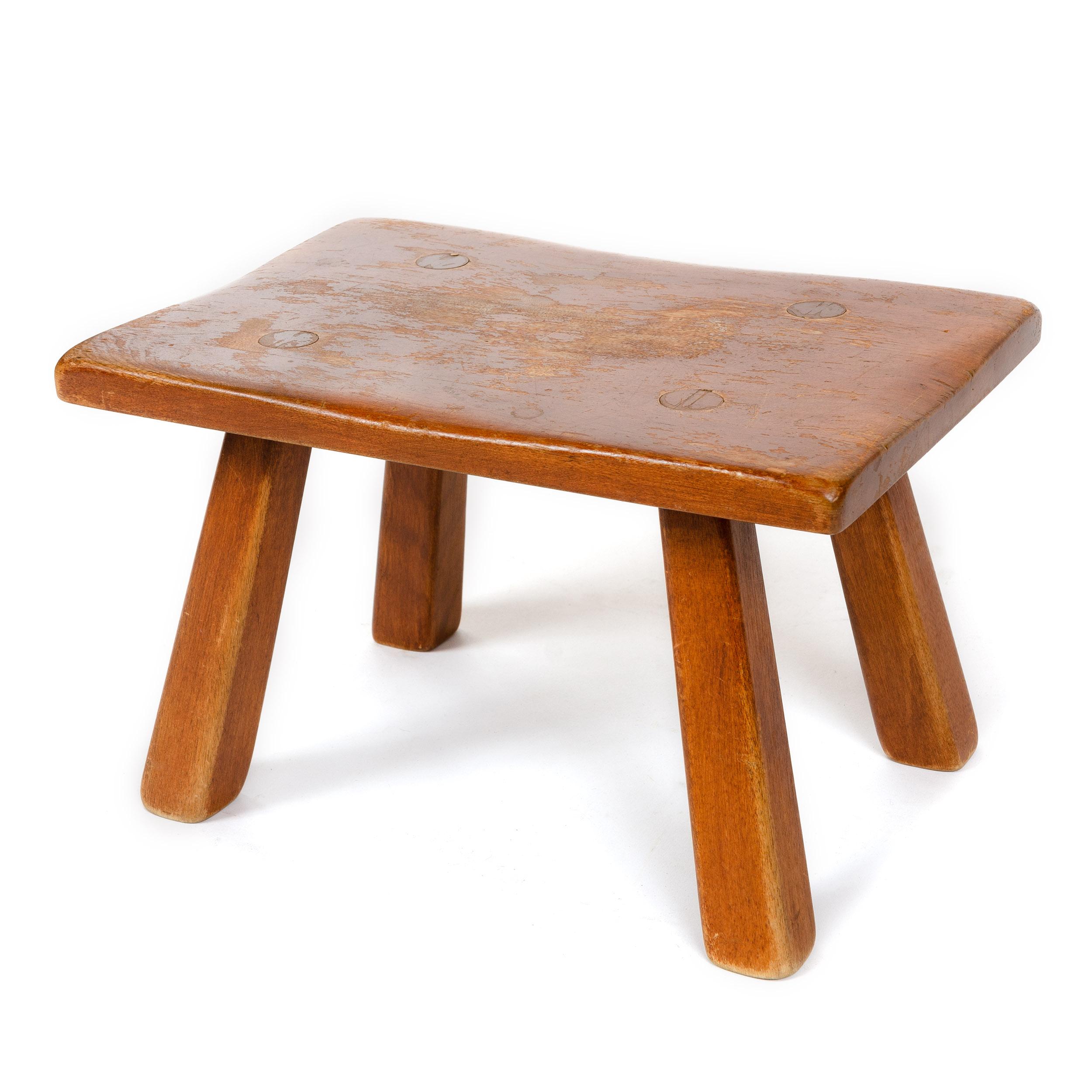 A stool in solid yellow birch with an organically shaped top and splayed legs, from the 'Colonial Creations' series.
