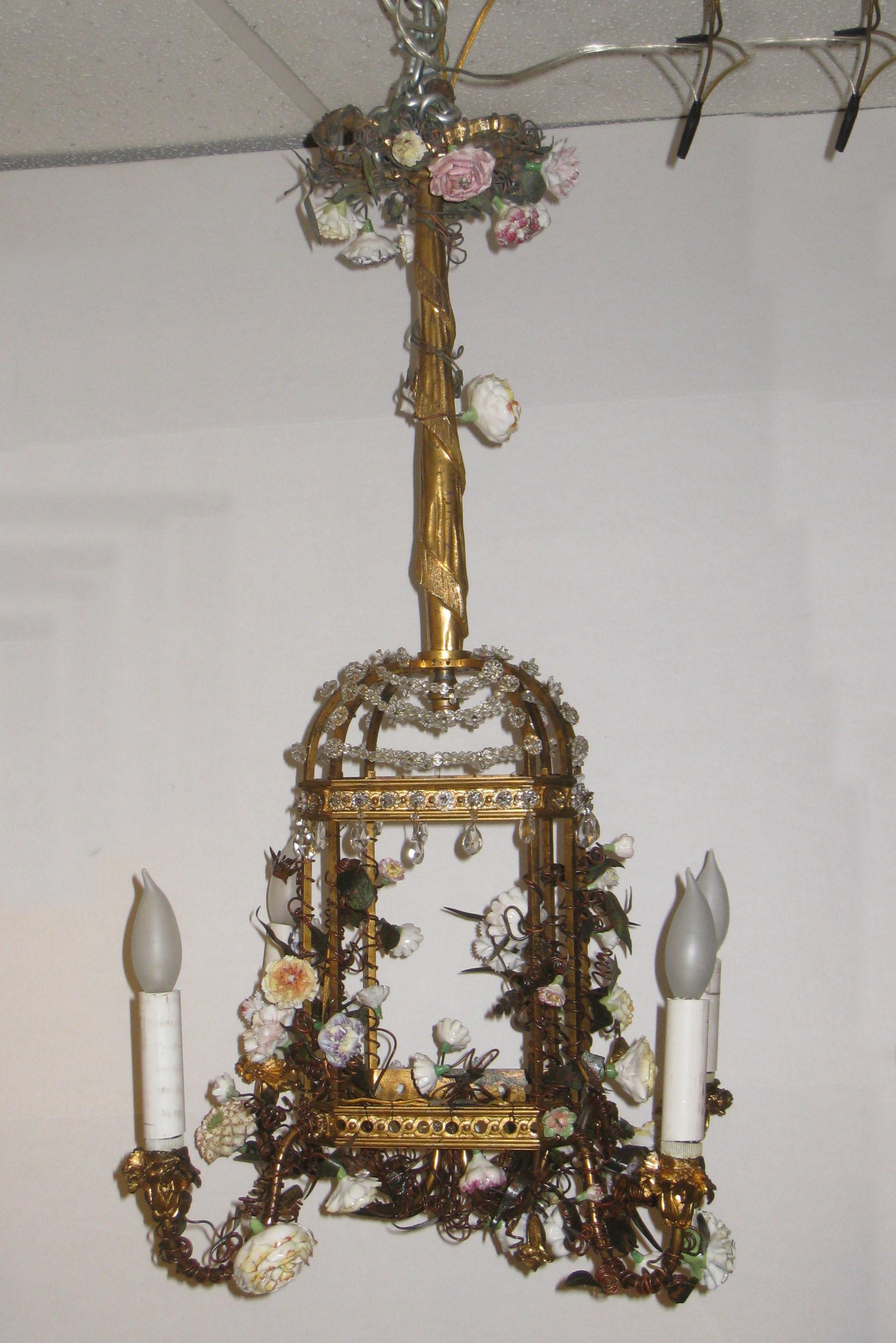 Finest French Louis XVI style 19th century bird cage form gilt bronze, tole, and crystal chandelier with applied porcelain flowers.