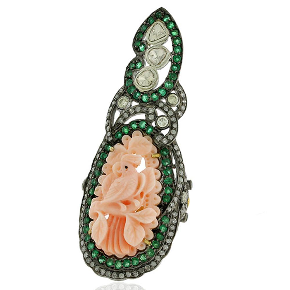 Long and attractive this Bird Carved Coral Knuckle Ring with diamonds and emerald is beautiful looking.

Ring size: 7 ( can be sized )

18Kt: 2.49g
Diamond:1.91Ct
Silver: 8.56g
EMERALD:1.5Ct
CORAL:13.3Ct