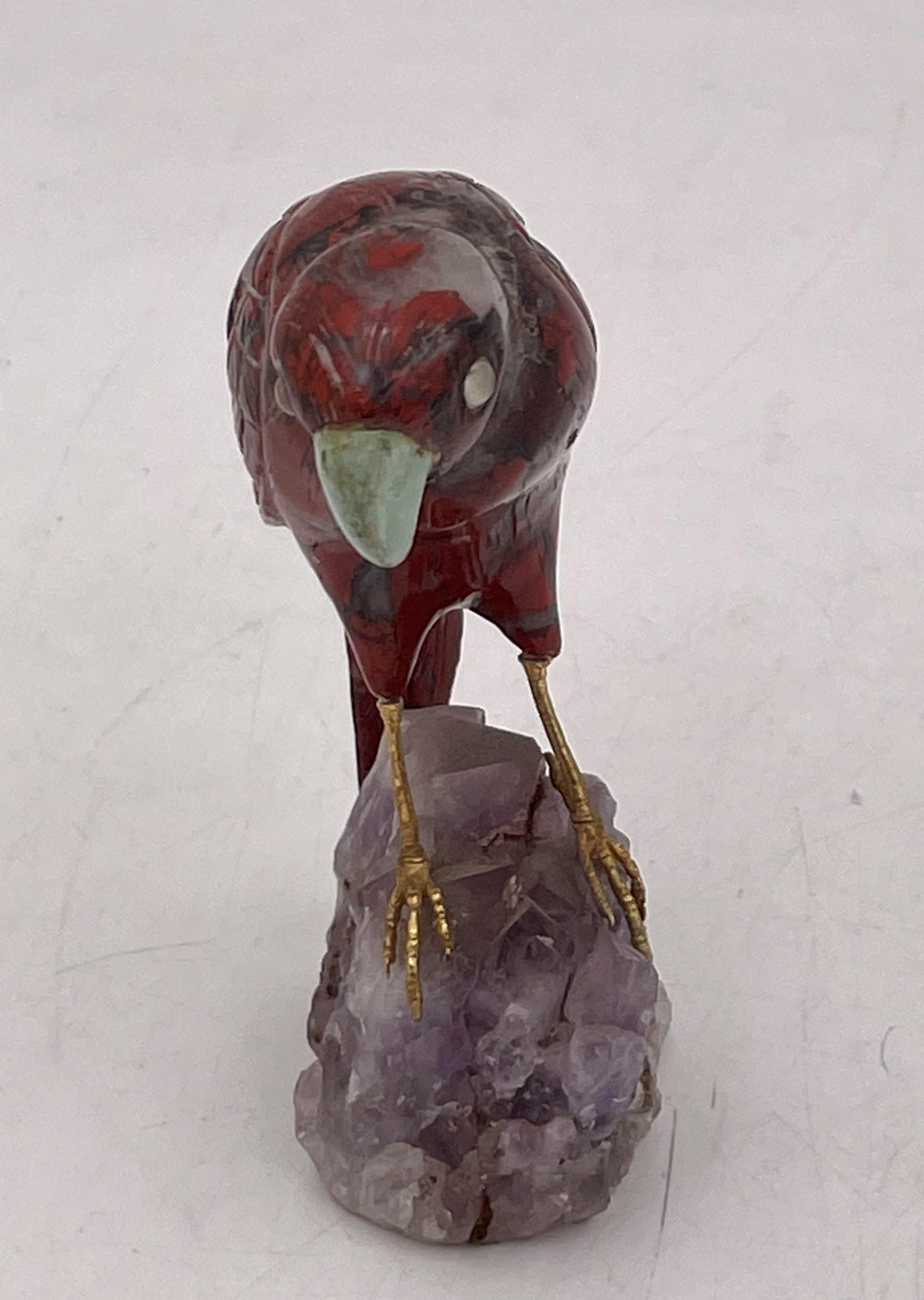 Highly realistic and detailed sculpture of a bird with gilt silver legs perched on an amethyst base. This beautiful piece measures 3 7/8'' in height by 2 3/4'' in depth by 1 1/2'' in width.

We hand polish all items before shipping them out, but