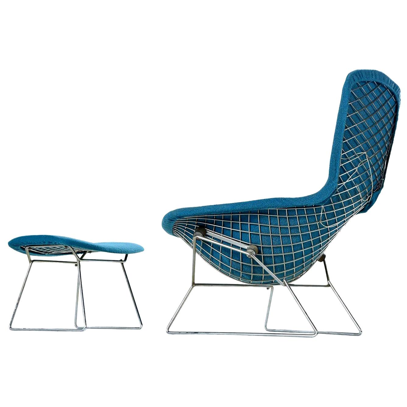 Vintage original Harry Bertoia bird chair and ottoman. Polished chrome stainless steel rod construction upholstered in original, curly cue bouclé blue fabric.

The bird chair is an astounding study in space, form and function by one of the master