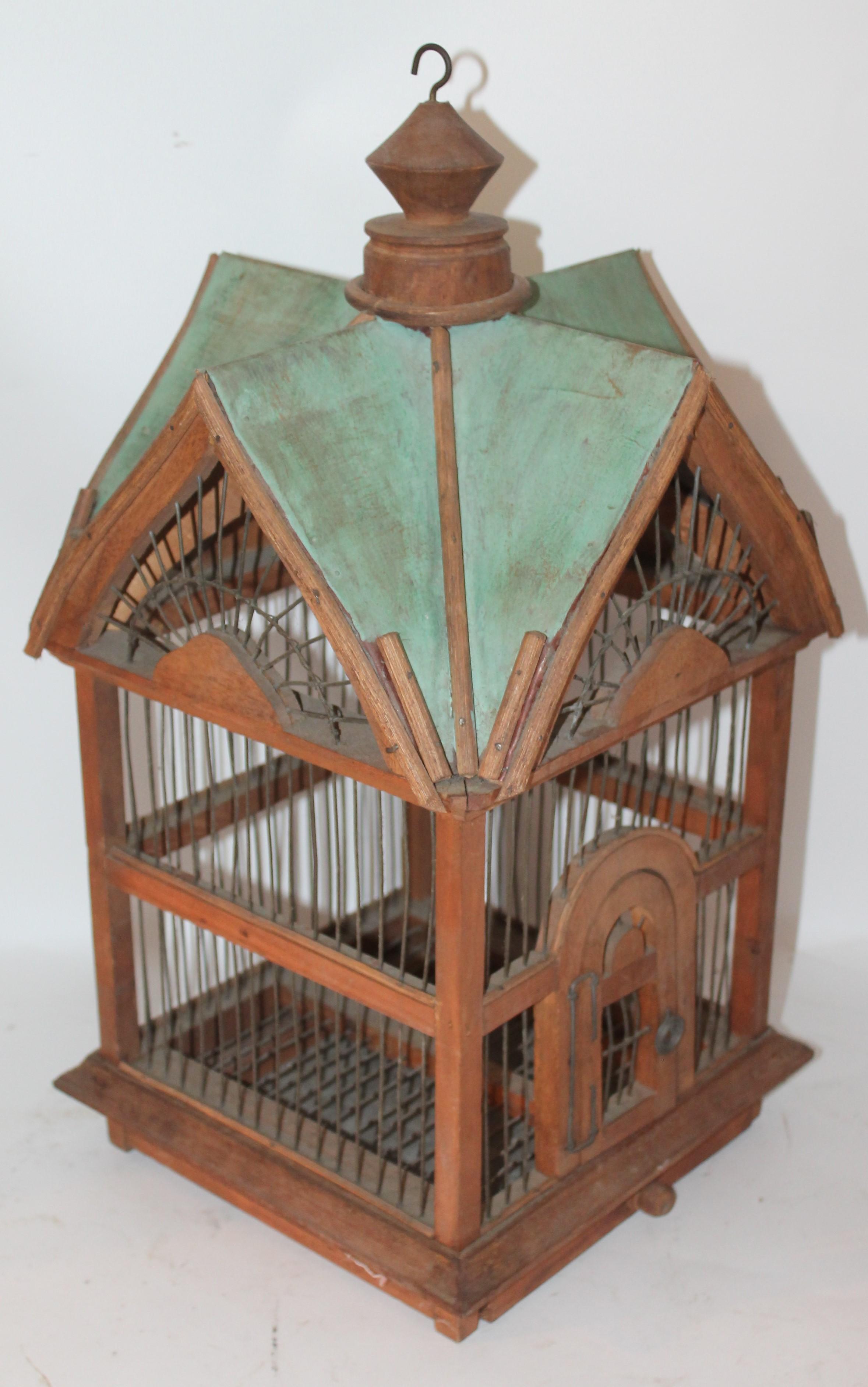 This painted and wire midcentury folky bird house was found in the mid west. The condition is good with wear consistent from age and use.
