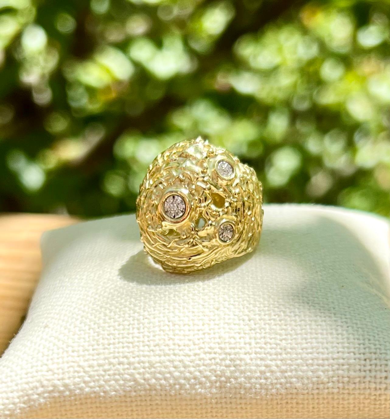 One 18 karat yellow gold bird nest design dome ring set with twenty-eight pavé set diamond clusters in a white gold bezel.  The ring is stamped with 