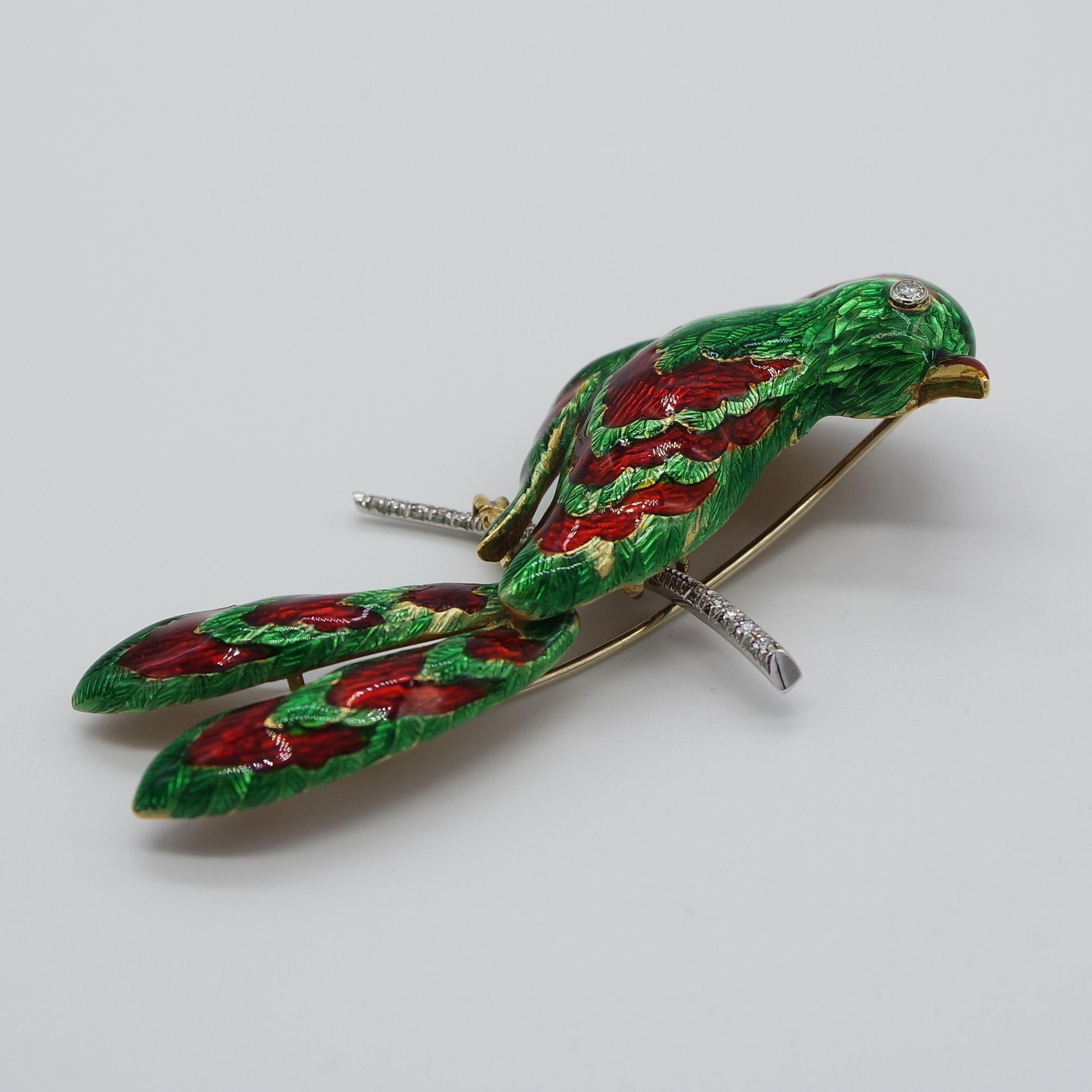This brooch, in 18 karat, yellow and white gold  depicts a splendid tropical bird, and more specifically a Paradise Bird  with green and red  guilloché enamel decorations and small brilliant cut diamonds.
It has a single clasp. 
The position of the