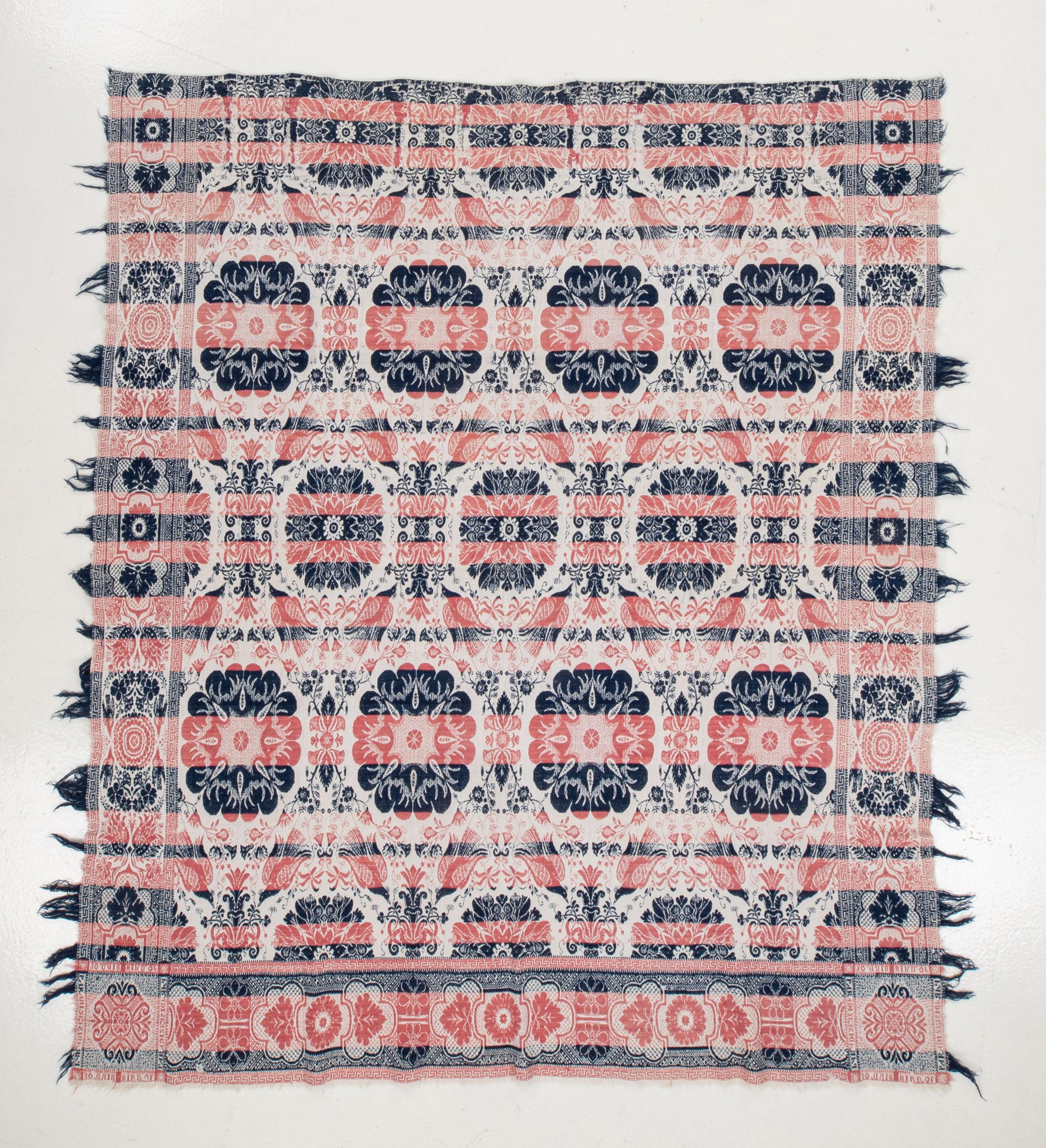 An American coverlet with some ware due to age and use with a dames design called 'bird of paradise'.
American coverlets are woven bed coverings that have a rich history in the United States. They were widely popular from the late 18th century
