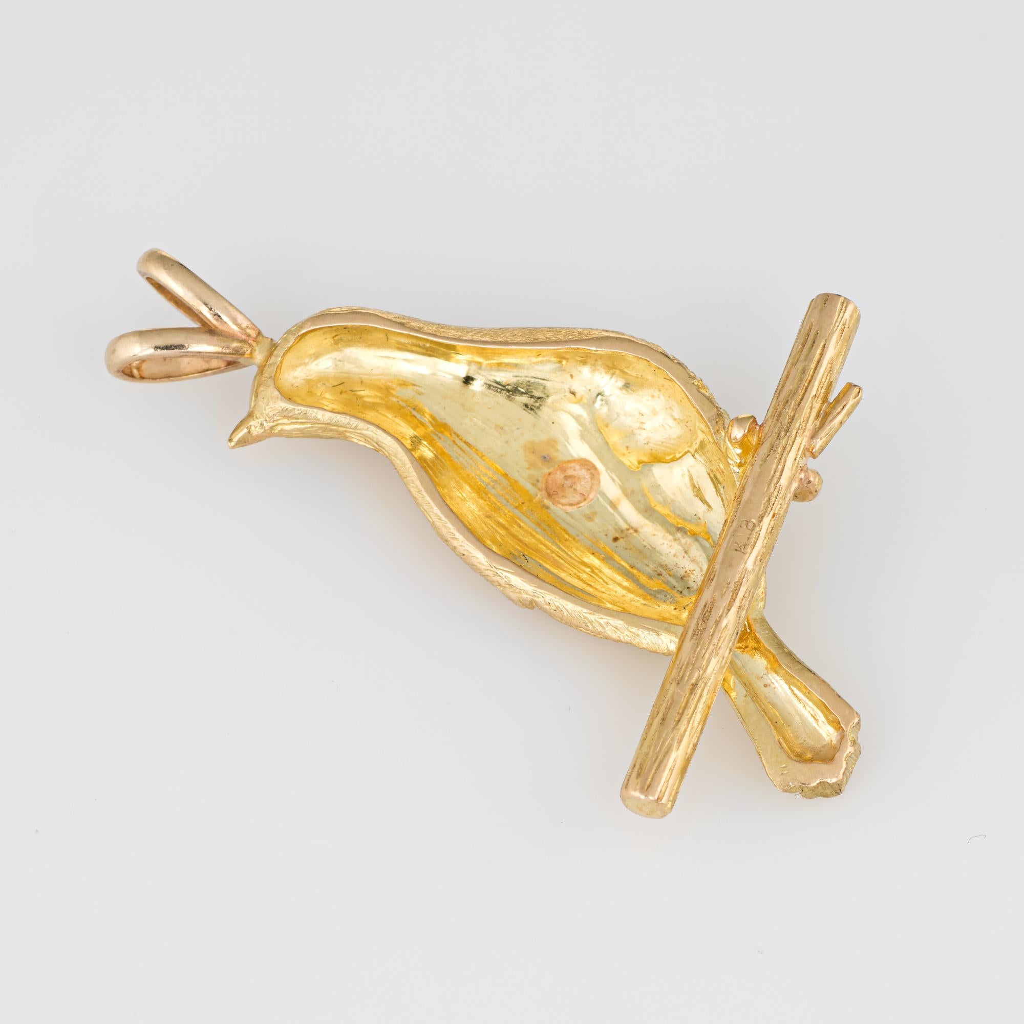 Finely detailed vintage bird on a branch pendant crafted in 18k yellow gold.  

The nicely detailed pendant can be worn on a chain or as a charm on a bracelet. The bird features lifelike detail with a muted brushed gold effect.    

The pendant is