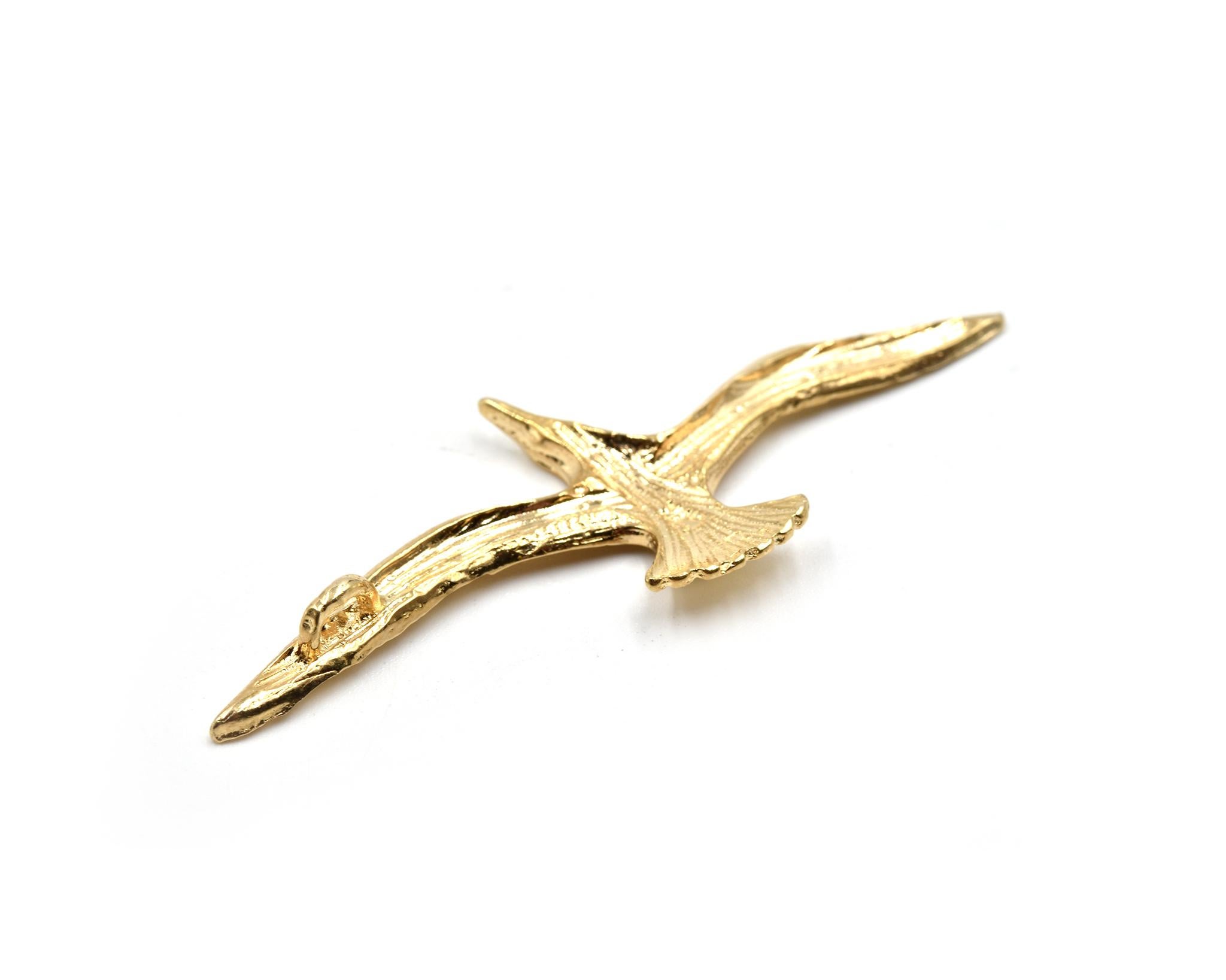 Designer: custom design
Material: 14k yellow gold
Dimensions: bird pendant is 2 1/2-inch long and 3/4-inch wide
Weight: 4.64 grams
