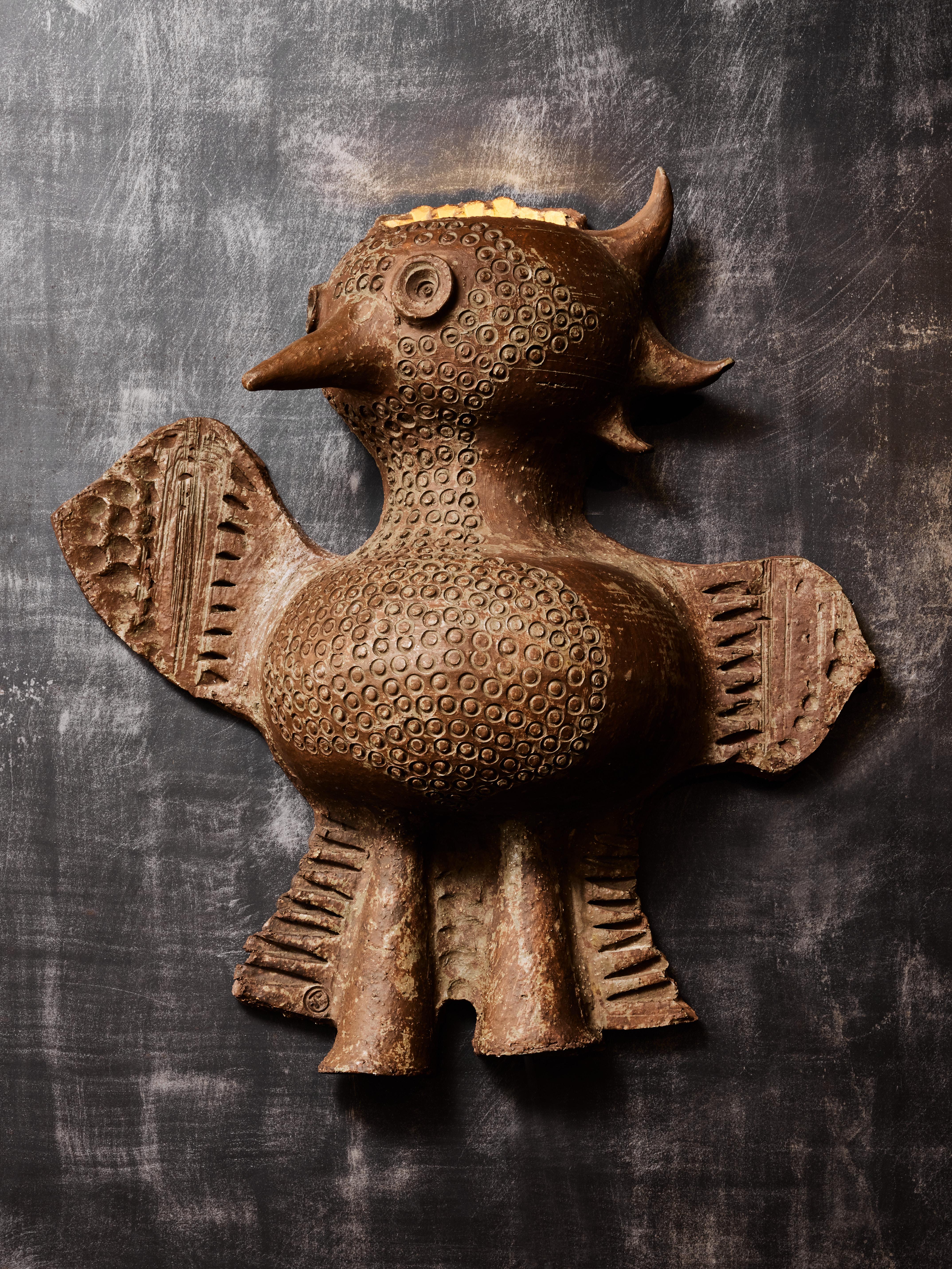 Impressive wall sconce by the French ceramist Jacques Pouchain made of red ceramic, shaped like a mystical bird. Stamp of the artist on one of the wing.

Jacques Pouchain (1927-2015)
Painter, sculptor and ceramist, best known for his ceramics