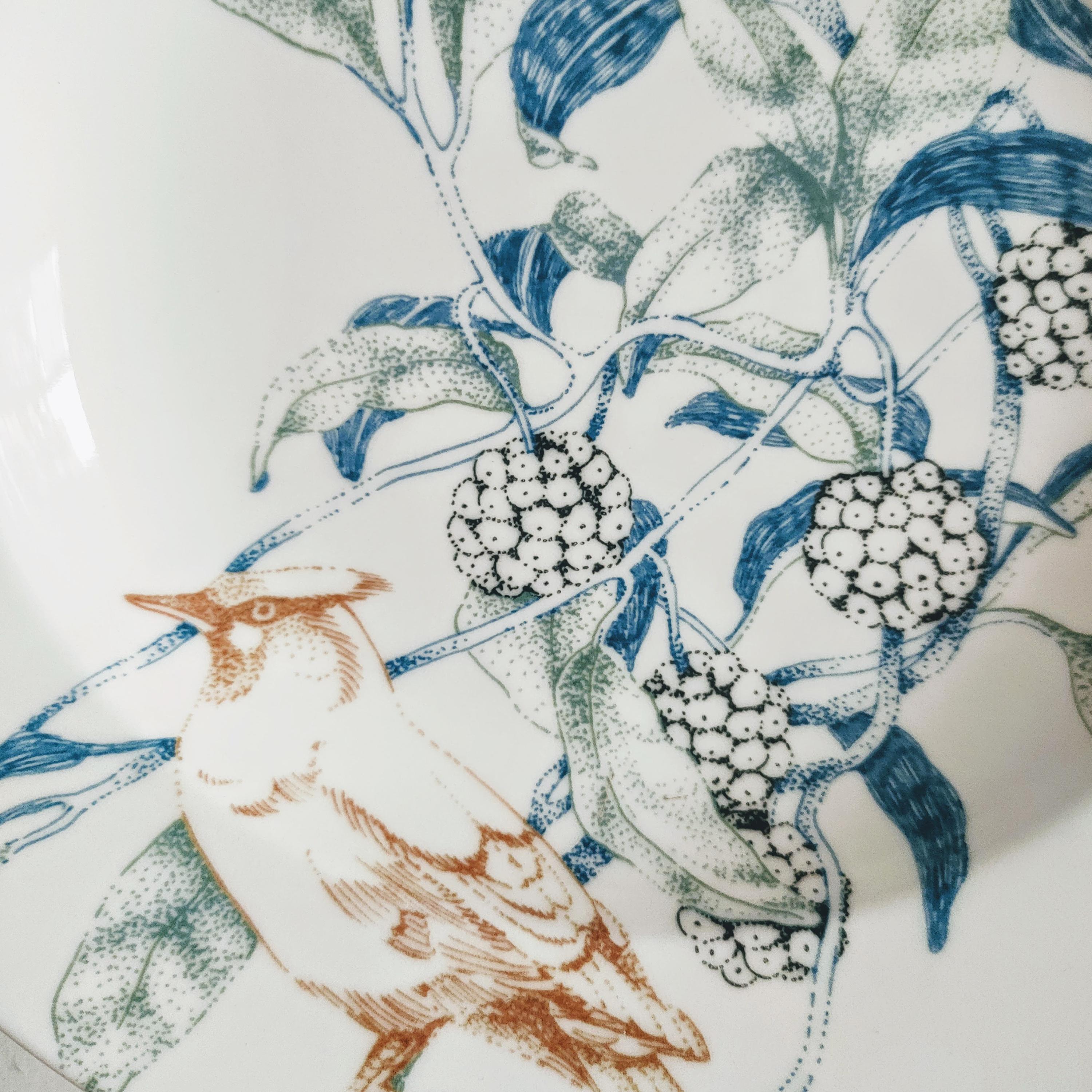 The Bird Song collection, features a design of wild birds hiding among delicate and intricate foliage in soft shades of blue, terracotta and dusty green. Originally created using the 'pointillism' technique, each scene, illustrated in detail,