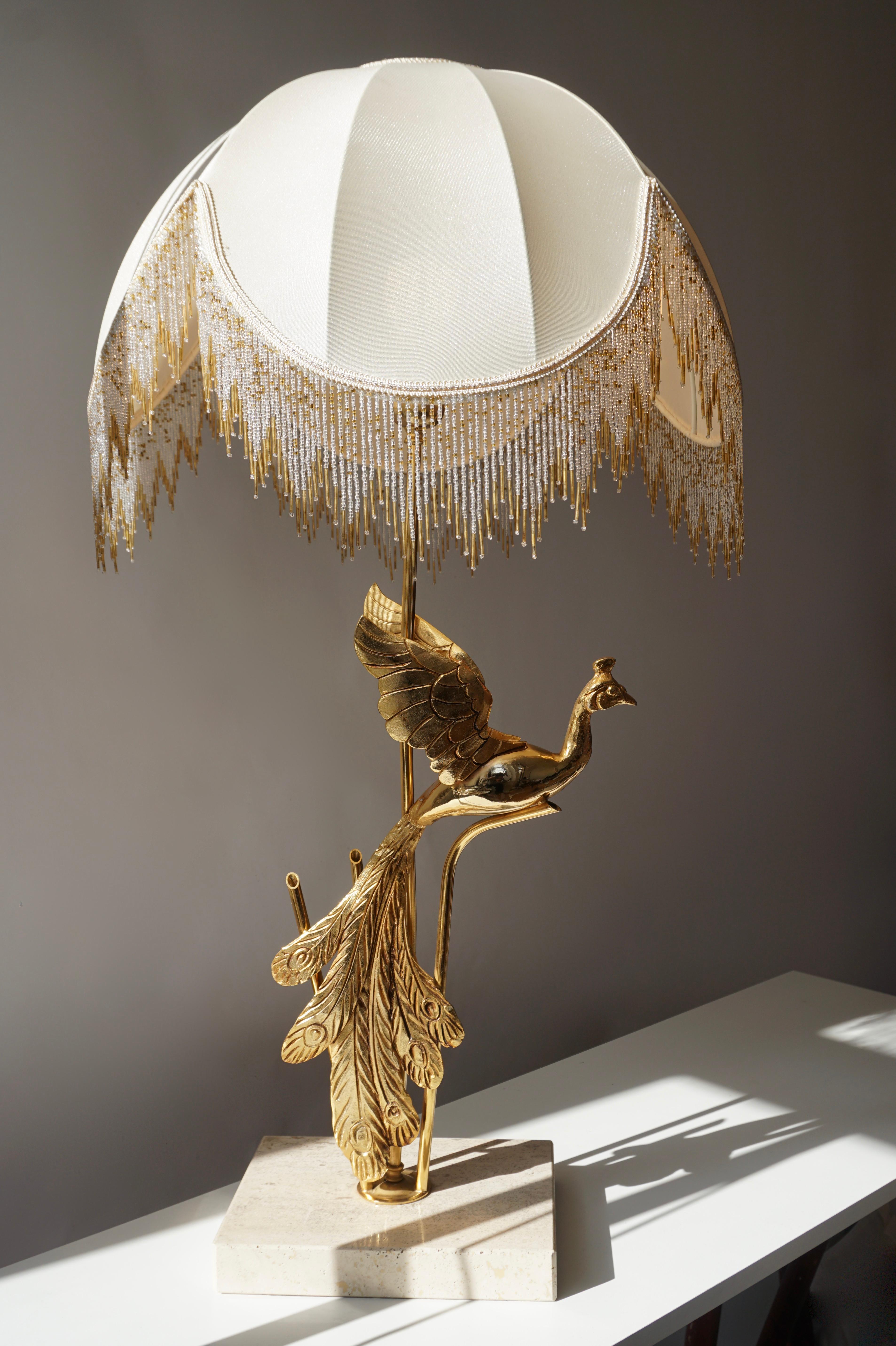 A truly eye-catching, unusual gilt metal table or floor lamp, fashioned in the shape of a Peacock. Designed in the style of Maison Jansen and produced circa 1970s in Italy. The Peacock has a beautiful original Patina and the lamp is in good