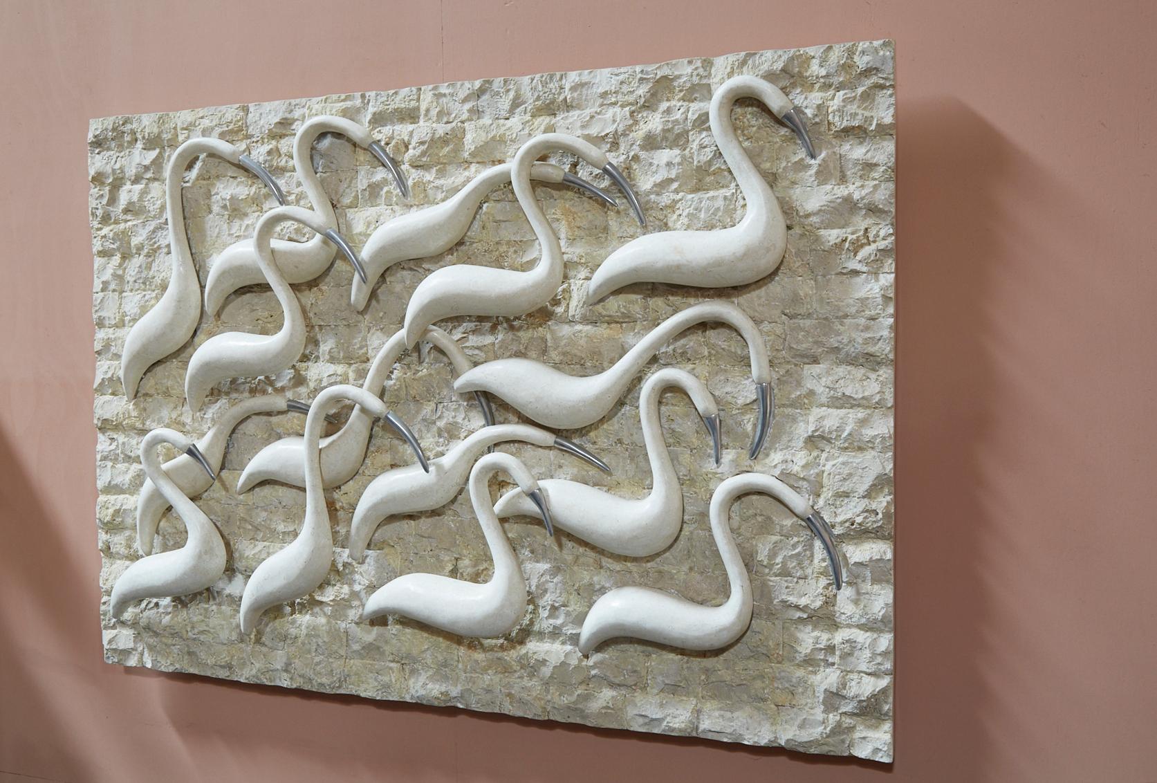 Fully inlaid with rough tessellated stone as a background, smooth stone birds with pewter beaks accentuate the foreground of this piece of sculptural wall art. All stone is handcut and inlaid onto a wooden and fiberglass body.

All furnishings are
