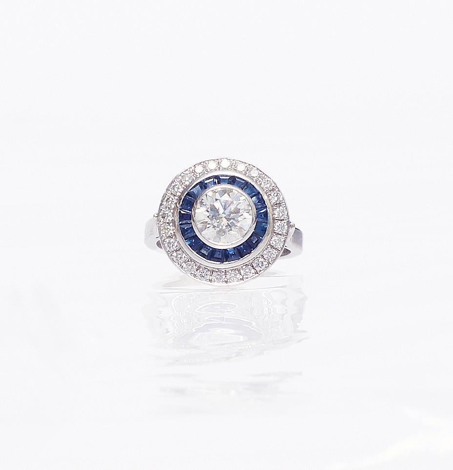 Perfect timeless coktail ring for your forever jewelry case. Certified 1,40 ct Diamond-SI2-H-I surrounded by 0,40 carat Diamond and 0,60 carat Princess Cut Sapphires. The cut and colour are matched to perfection.  Bird Eye Art Deco Style Ring 
US