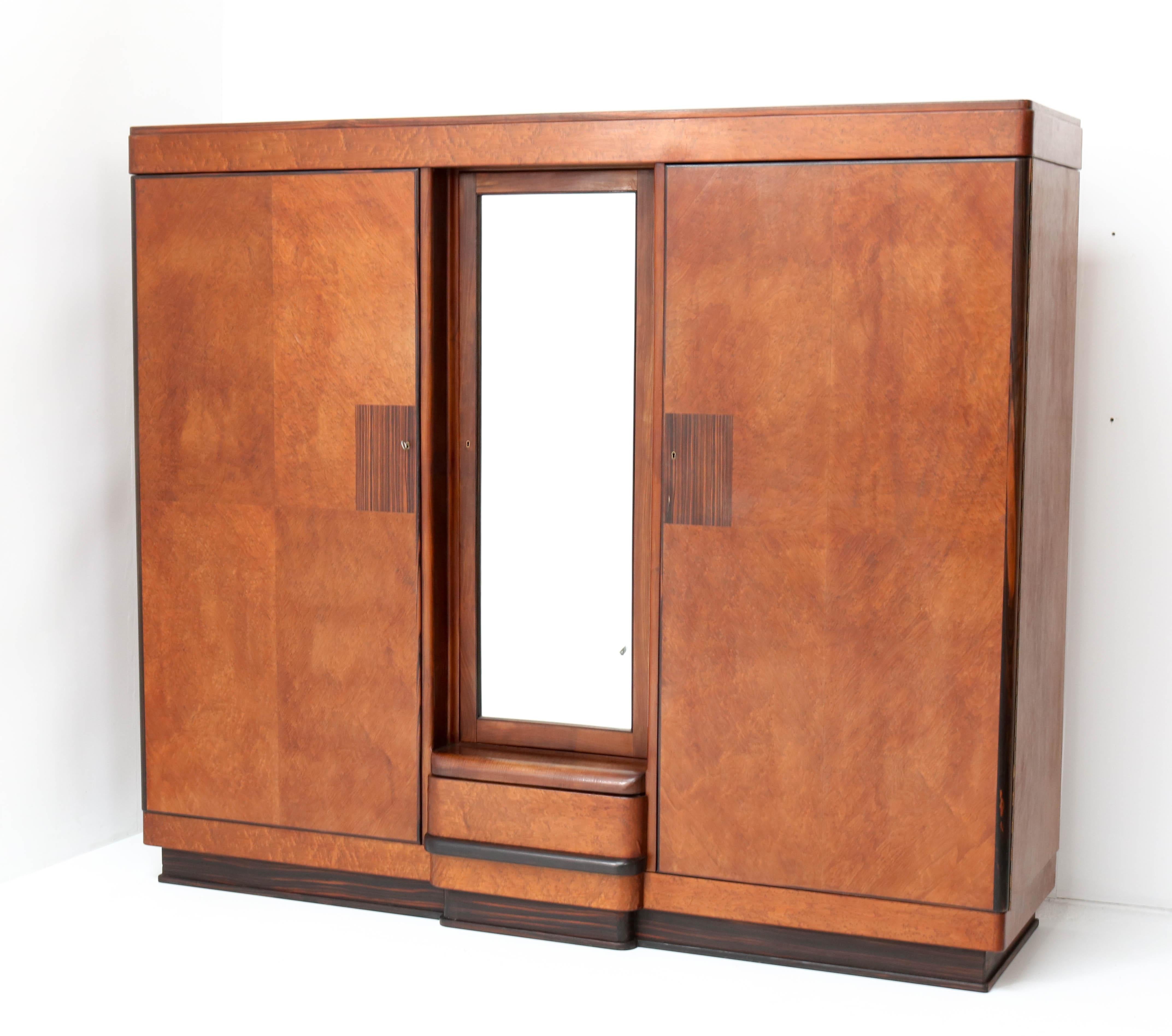 Magnificent and rare Art Deco Haagse School armoire or wardrobe.
Design by Anton Lucas for N.V. Meubelkunst Leiden.
Striking Dutch design from the 1920s.
Birdseye maple veneer with solid macassar ebony handle on the drawer.
Marked with original