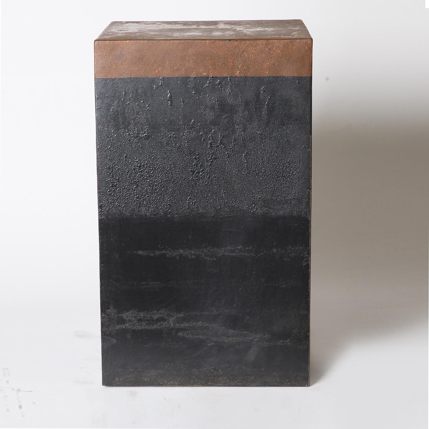 Sculptural table of waxed sheet Iron by Sciortino, the bottom portion of which is painted matte black, boldly contrasting the blighted finish on top. A hidden internal mechanism facilitates easy movement. 


  