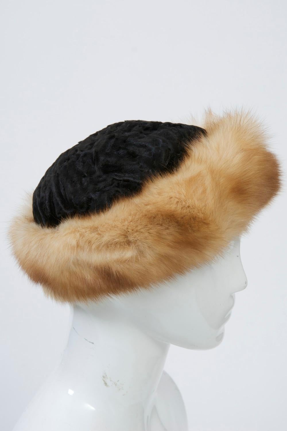 Black broadtail hat in cap style featuring a deep border of sable in light reddish brown - two luxury furs in one by noted furrier Birger Christensen of Denmark. Size S.