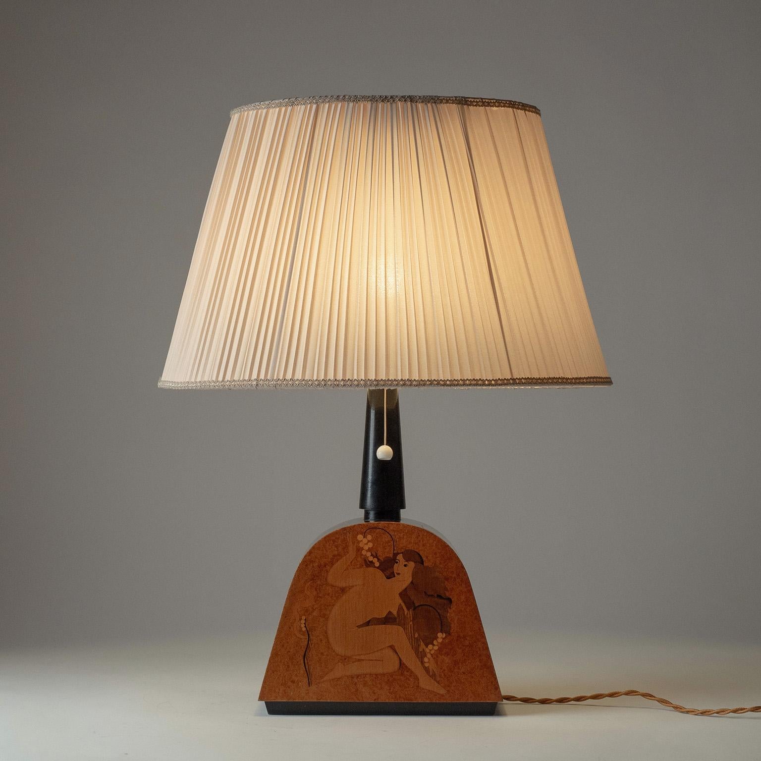 Rare Swedish marquetry table lamp by Birger Ekman from 1939. Arched base, depicting a female nude with floral decorations on front and back, executed in a variety of wood veneer. Very nice original condition with some light wear due to dryness of
