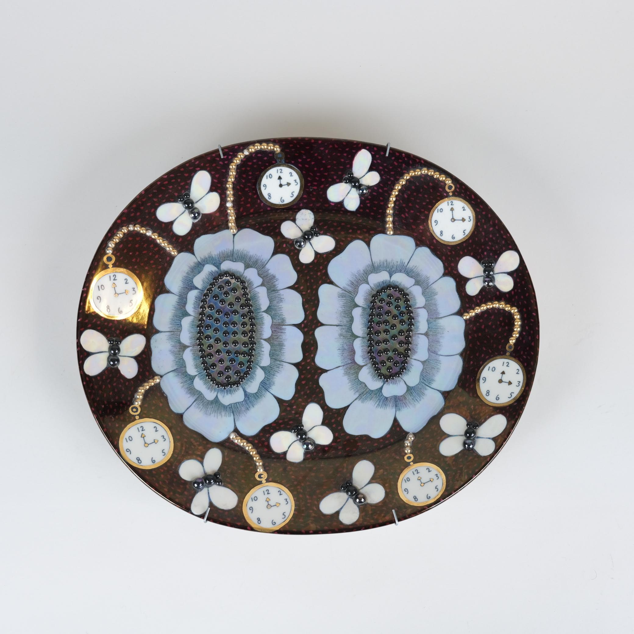 This is a beautiful ceramic plate decorated with multiple black and gold beadings and it is a good example of the artists skill to use colours and fine iridescent glaze dots and details on the surface of the plate. Kaipiainen introduced ceramic
