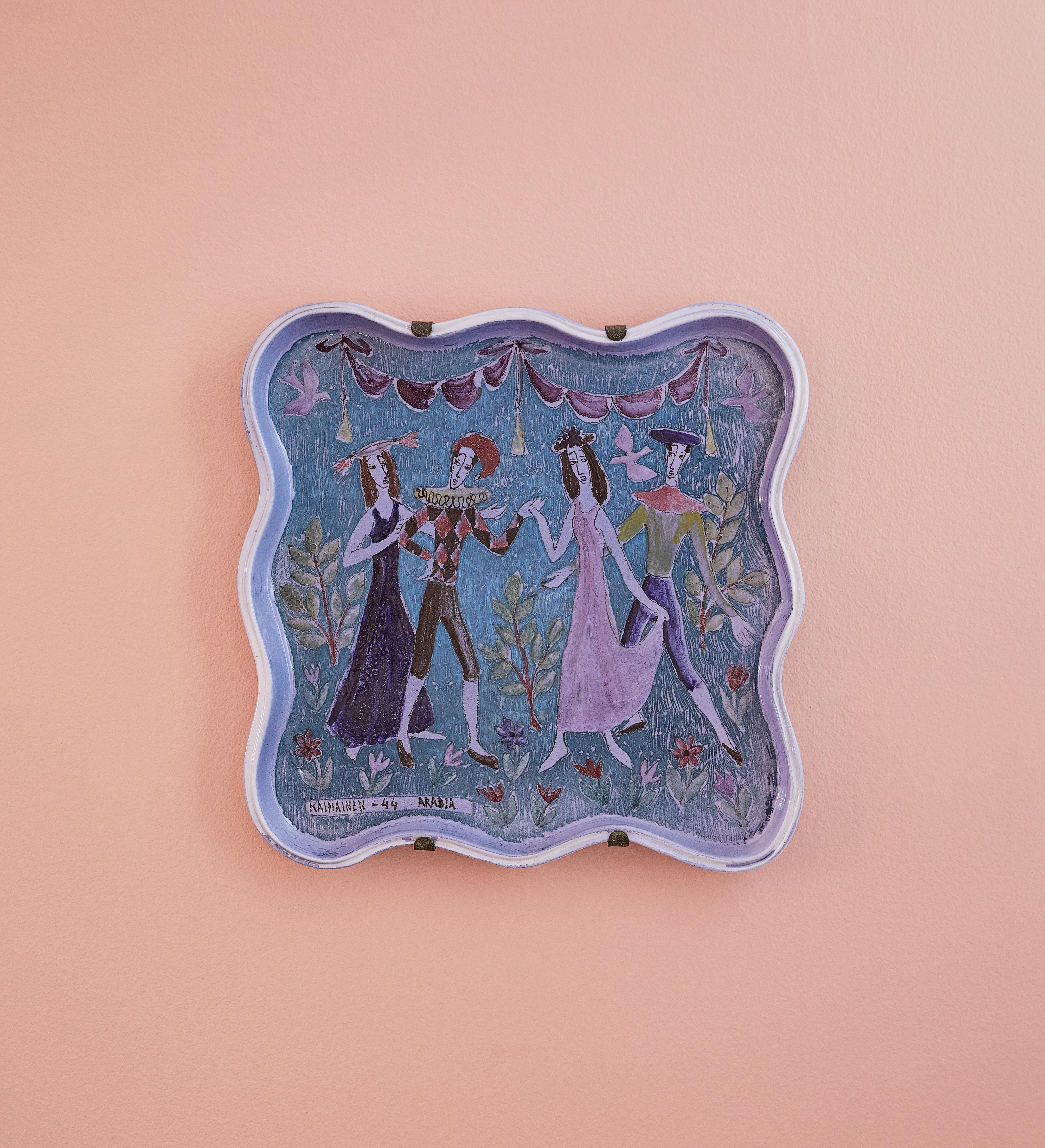 Ceramic hanging platter with decoration on blue fund.

Birger Johannes Kaipiainen (1915-88) graduated from the Central School of Arts & Crafts of Helsinki and worked for Finnish ceramics company Arabia for more than fifty years. Known as the