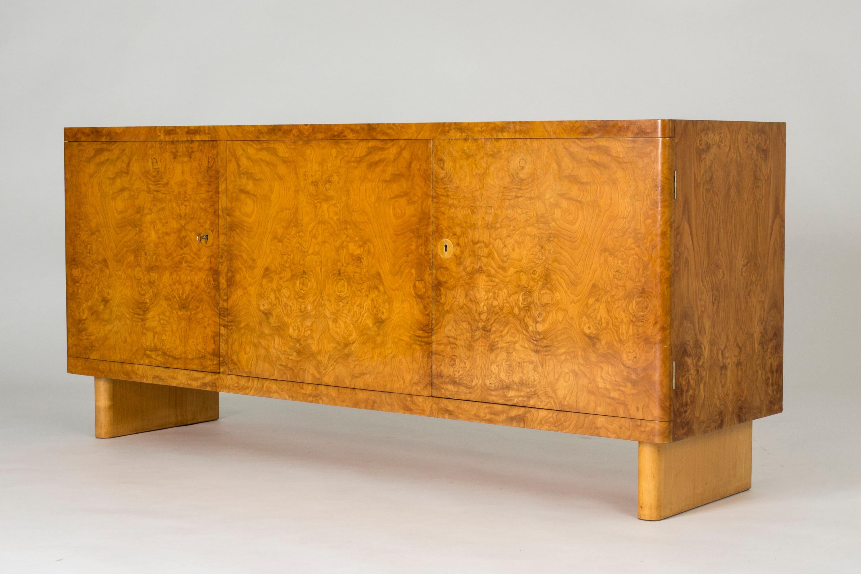 Stunning birch root sideboard by Axel Einar Hjort, model named “Birka”. Exceptionally cool, elegant and timeless design with a certain lightness notwithstanding the solid expression. Beautiful root veneer in very good condition, with some smaller