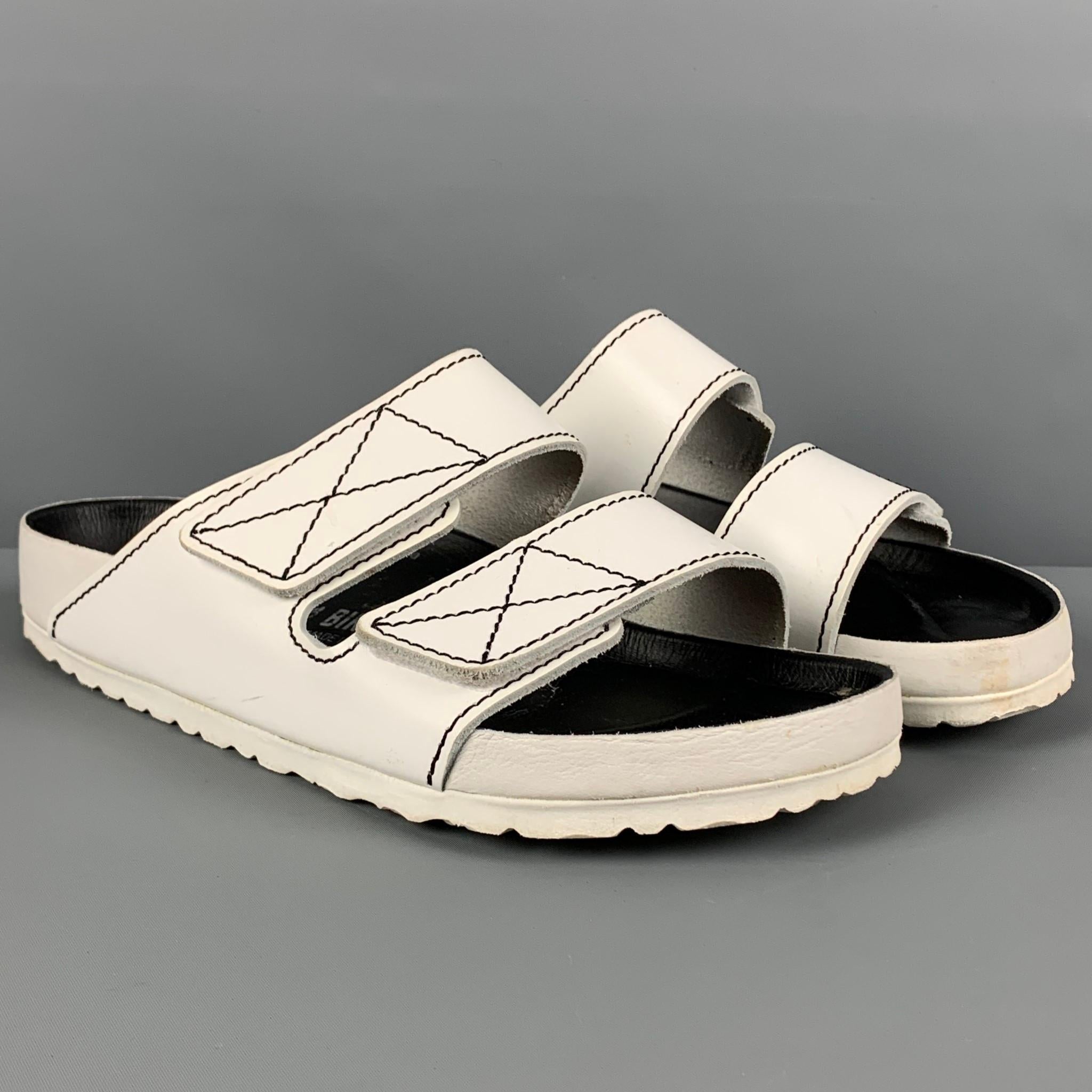BIRKENSTOCK x PROENZA SCHOULER sandals comes in a white leather featuring a black contrast stitch detail and a hook & loop closure. 

Good Pre-Owned Condition. Light wear. As-Is.
Marked: 42 270 L11 M9
Original Retail Price: $420.00

Outsole: 11.25