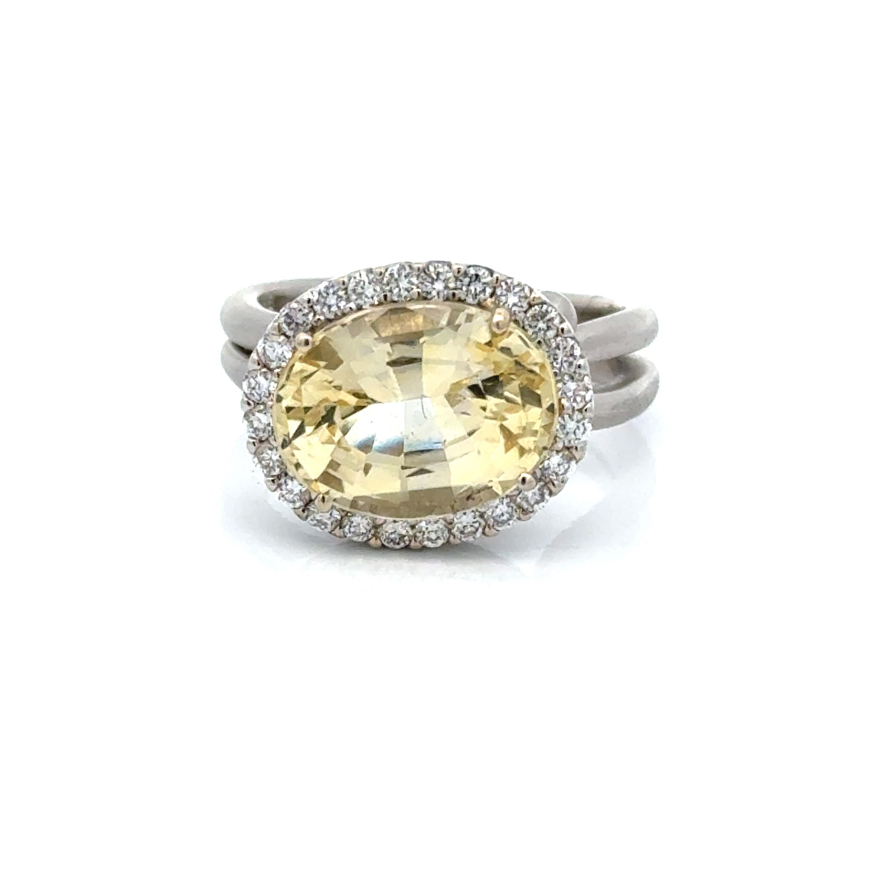 This Birks 18K Gold and Yellow Sapphire and Diamond Halo Ring is a truly special piece from premier Canadian jeweler Birks. The oval yellow sapphire, accompanied by a GIA report, boasts a natural beauty that has not been altered or enhanced by heat